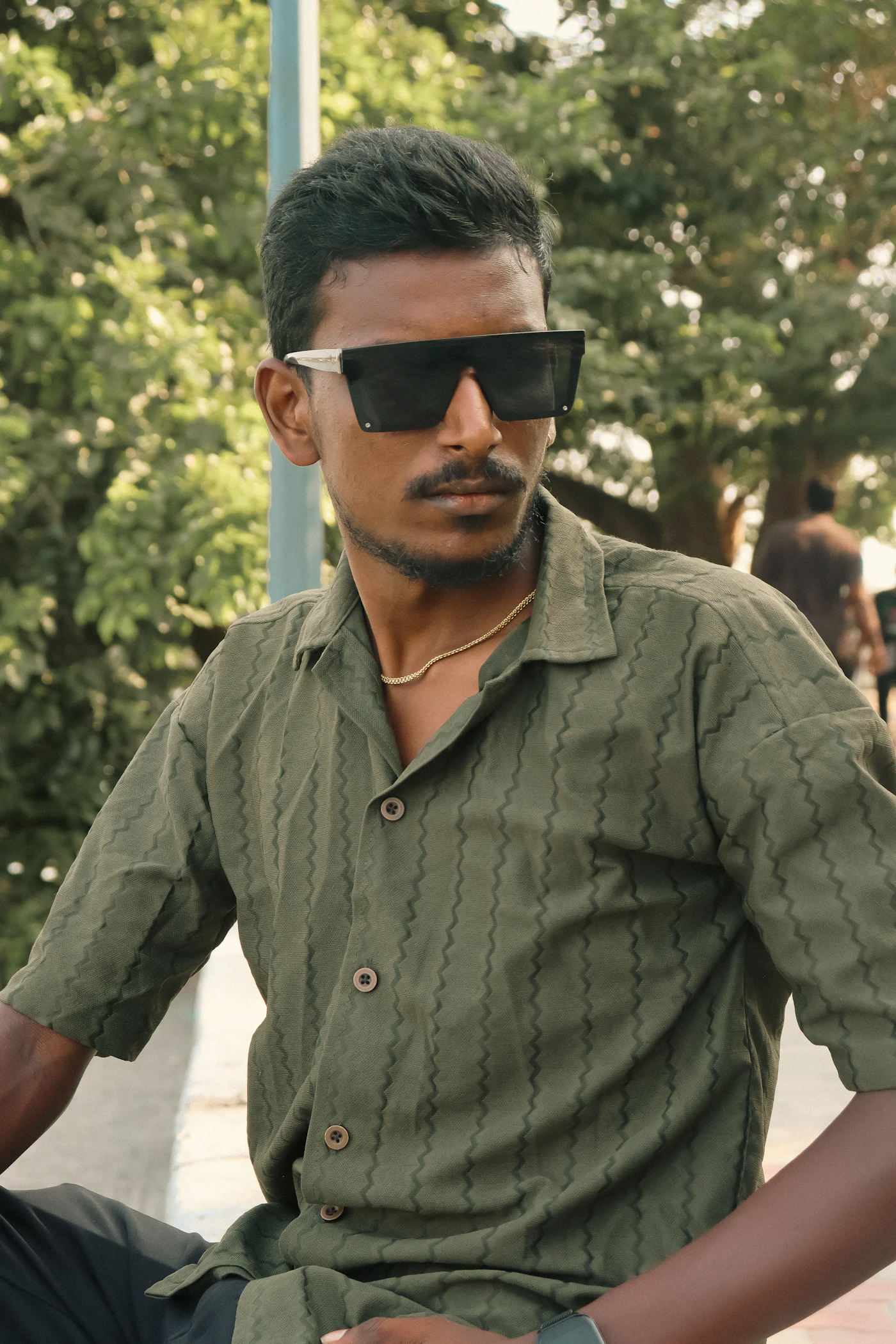 Man in sunglasses looking thoughtfully to the side