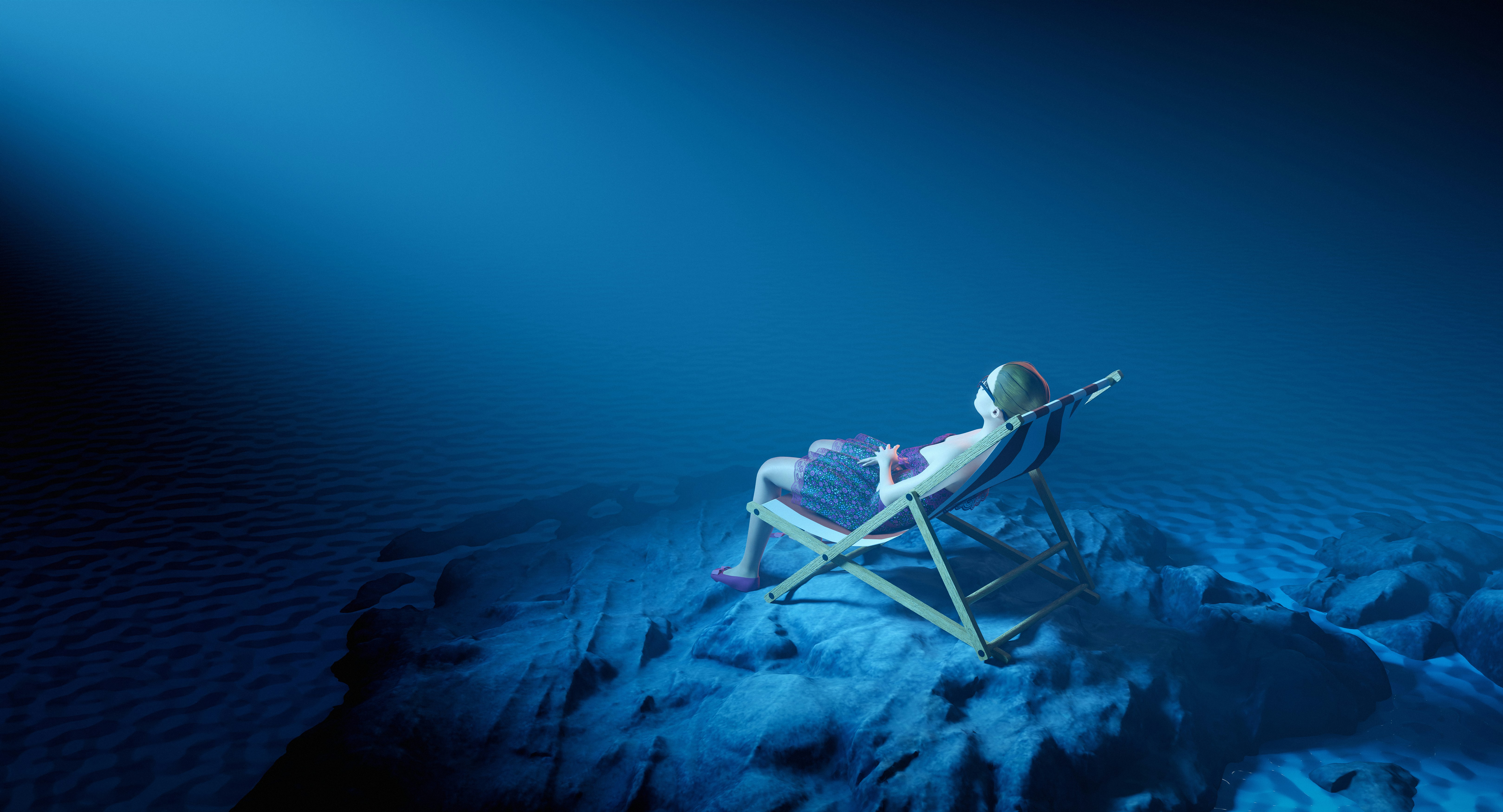 Woman relaxes in a chair underwater