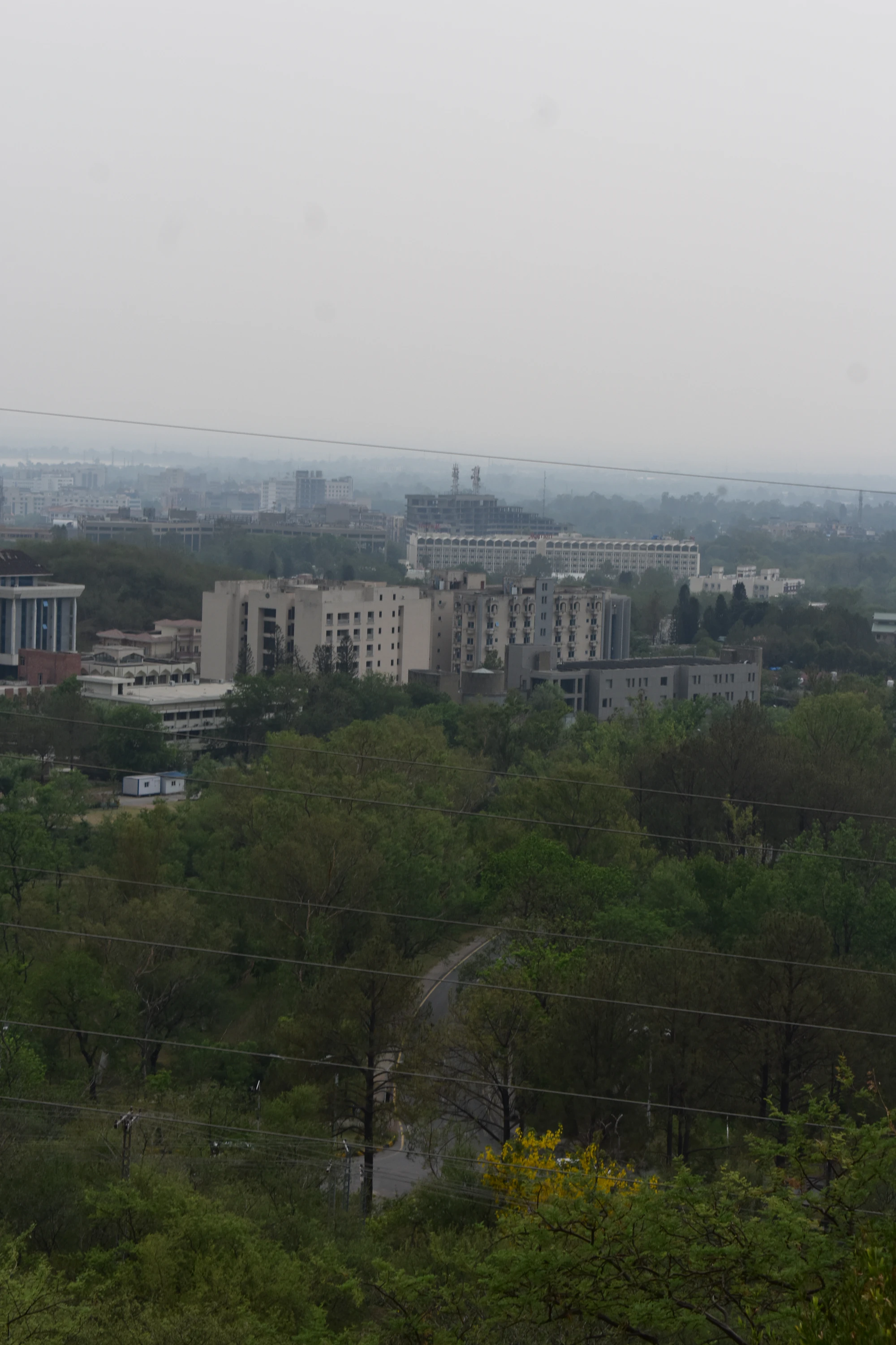 Buildings and trees forming a hazy city landscape in Islamabad