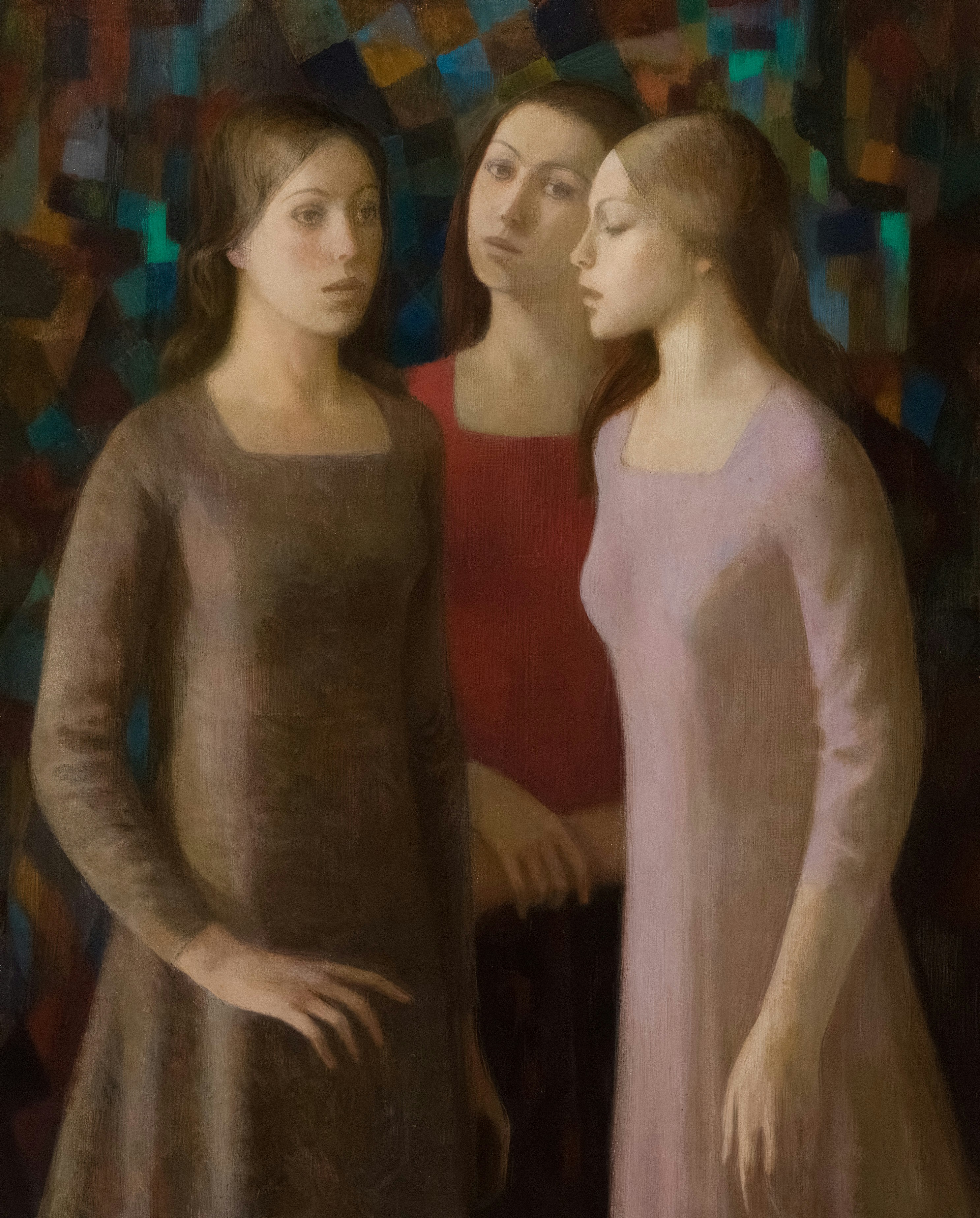 Three women in dresses stand together