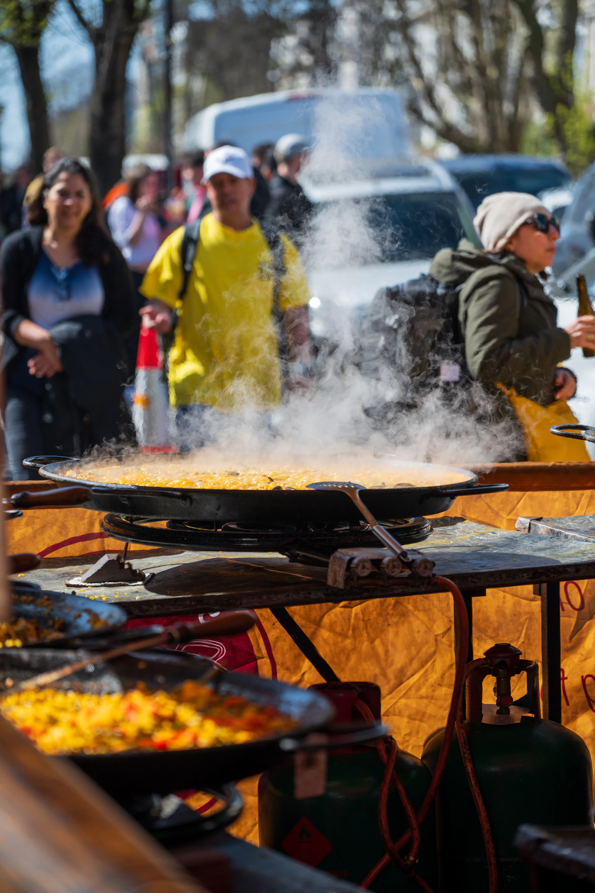 Street food cooking in a large pan.