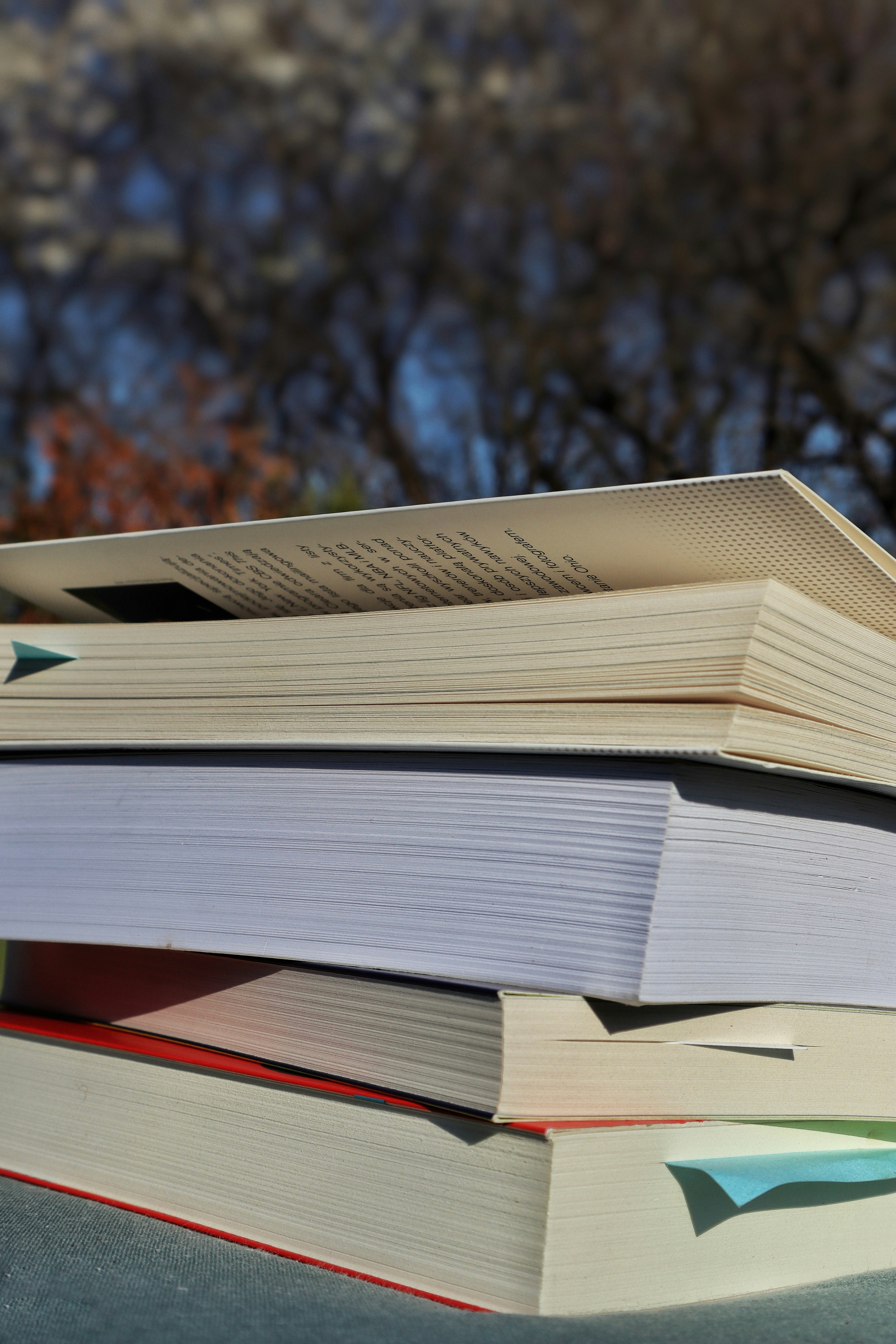 Books stacked on top of each other outside.