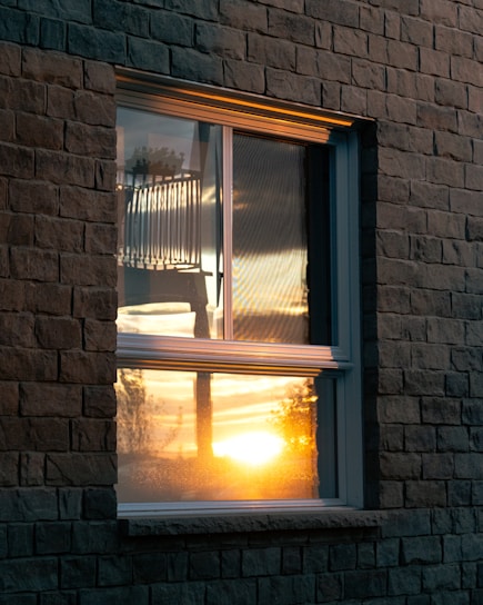 Sunset reflects beautifully through a window.