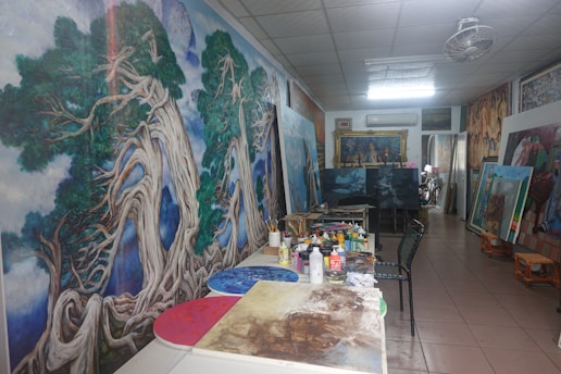 A painter's studio is filled with art and supplies.