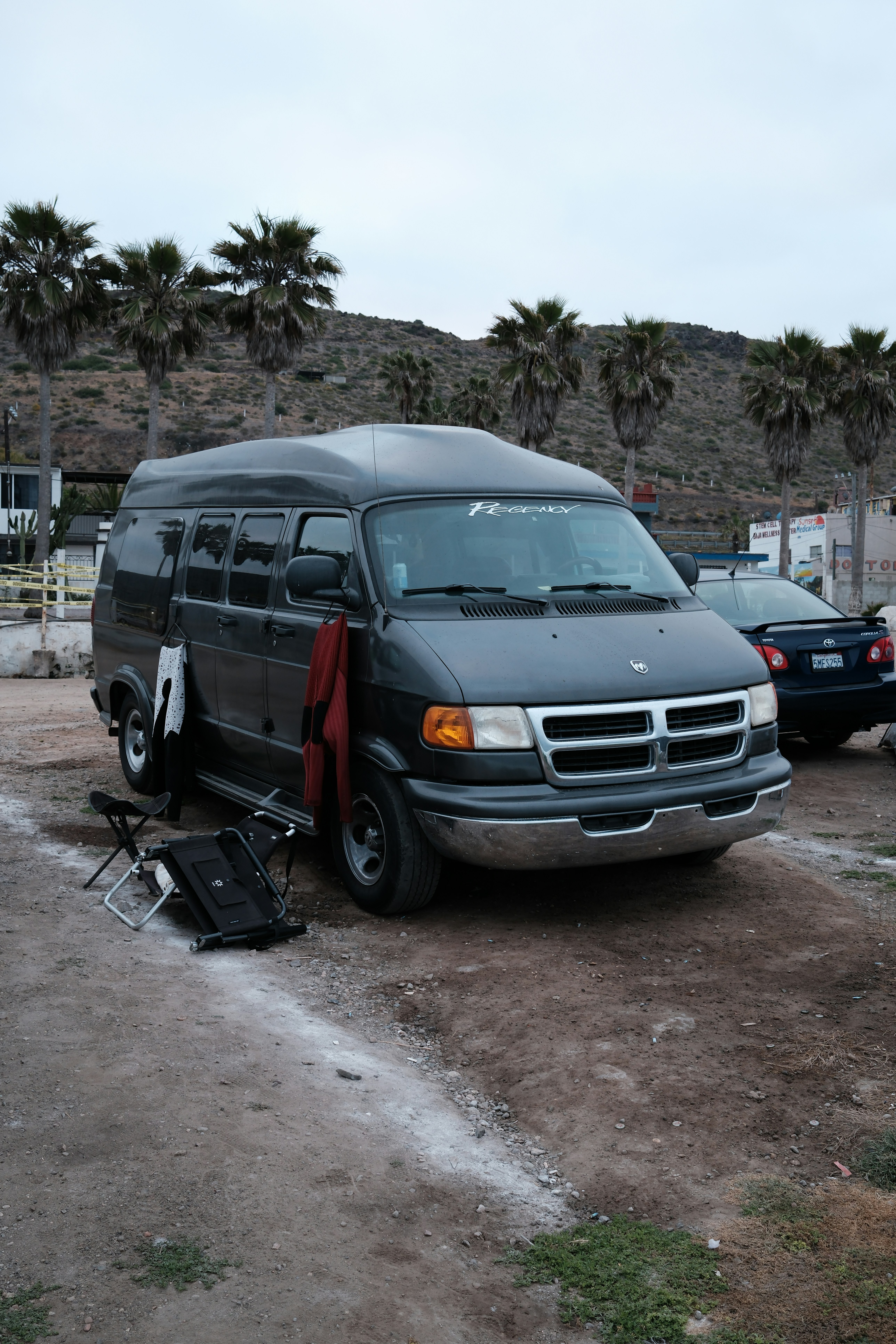 A van is parked by the beach.