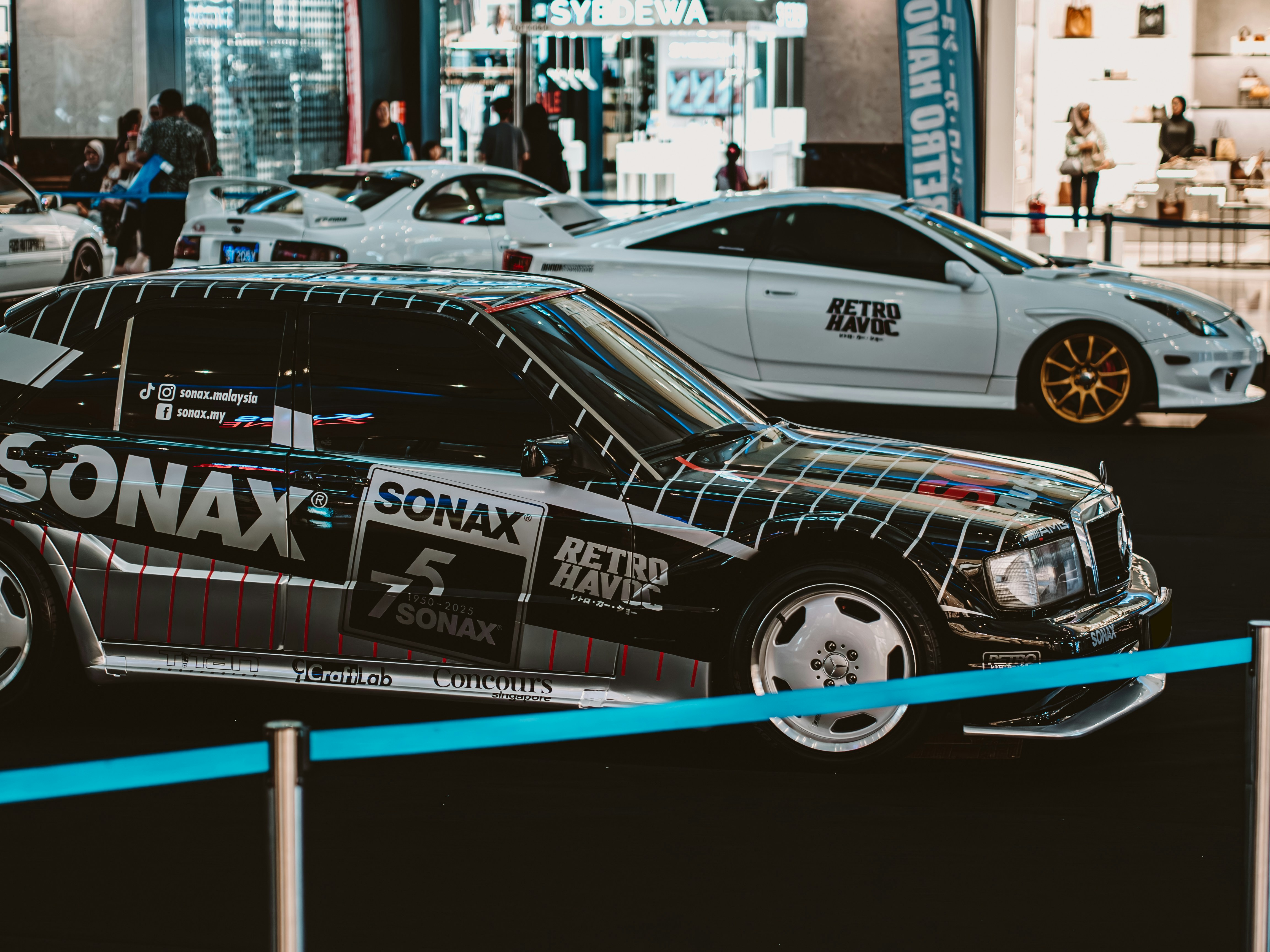 Several cars are on display at an auto show.