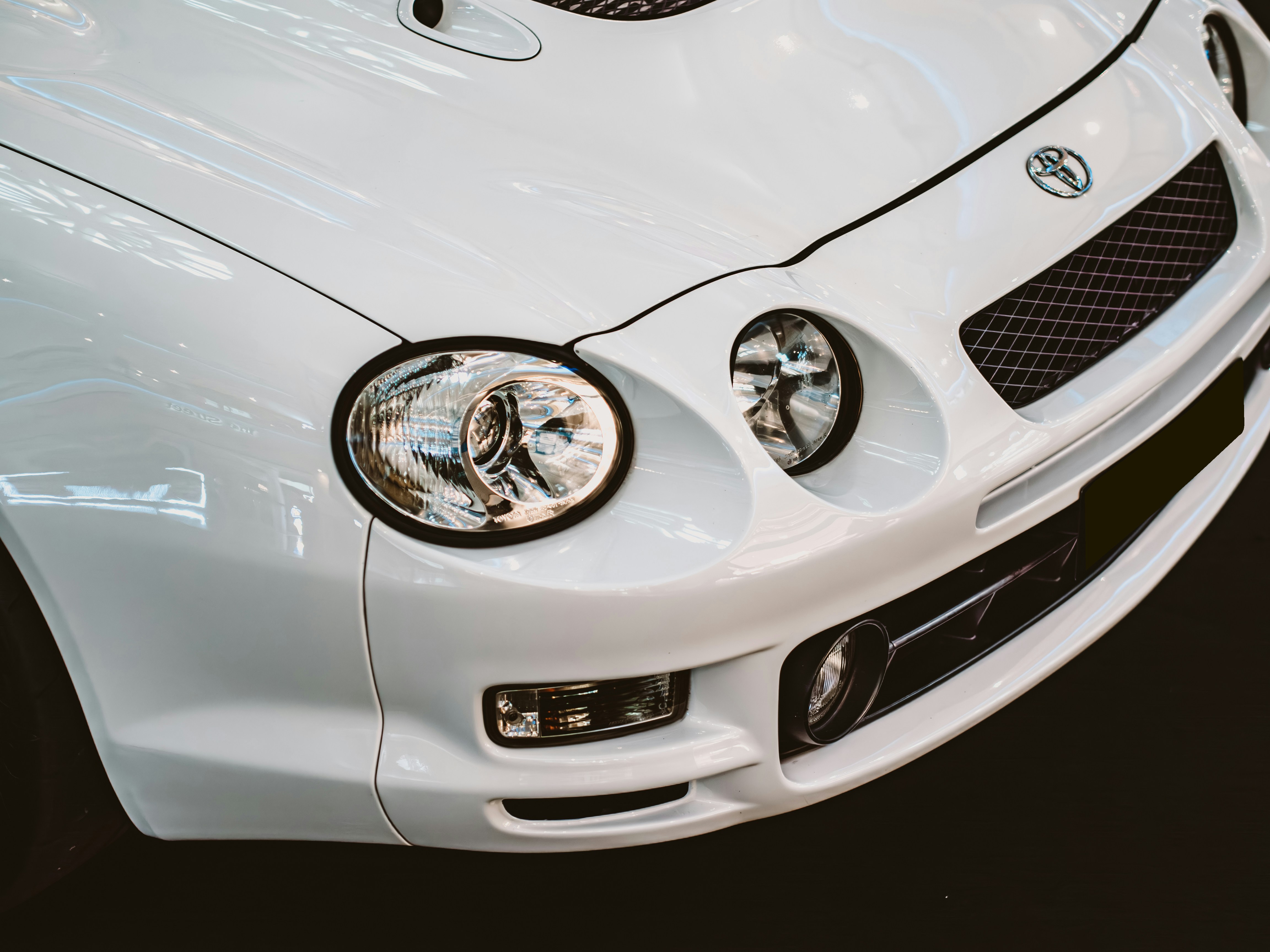 White toyota celica's front details are shown.