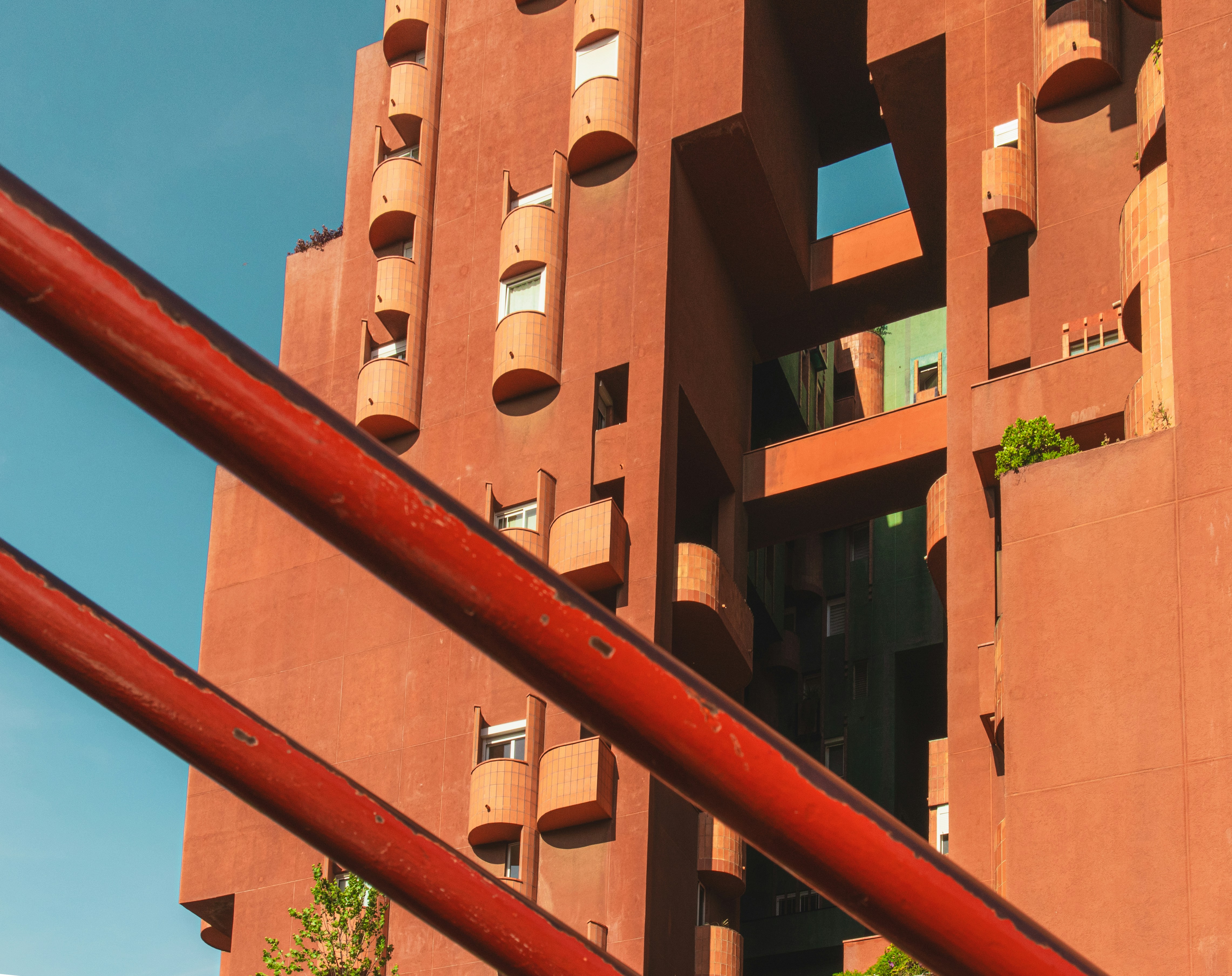 Unique red building with distinctive architecture.