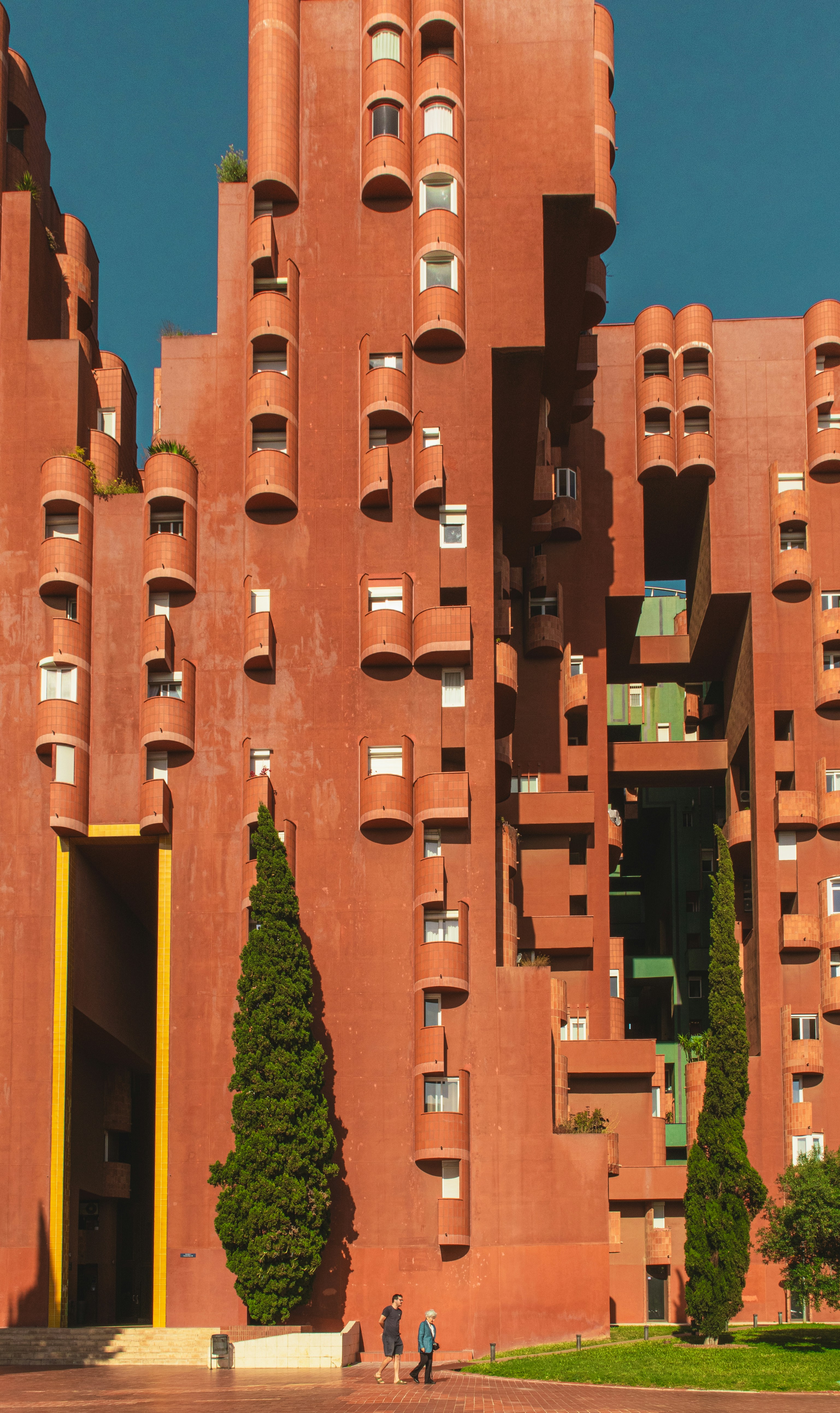 A unique red building with cylindrical extensions.