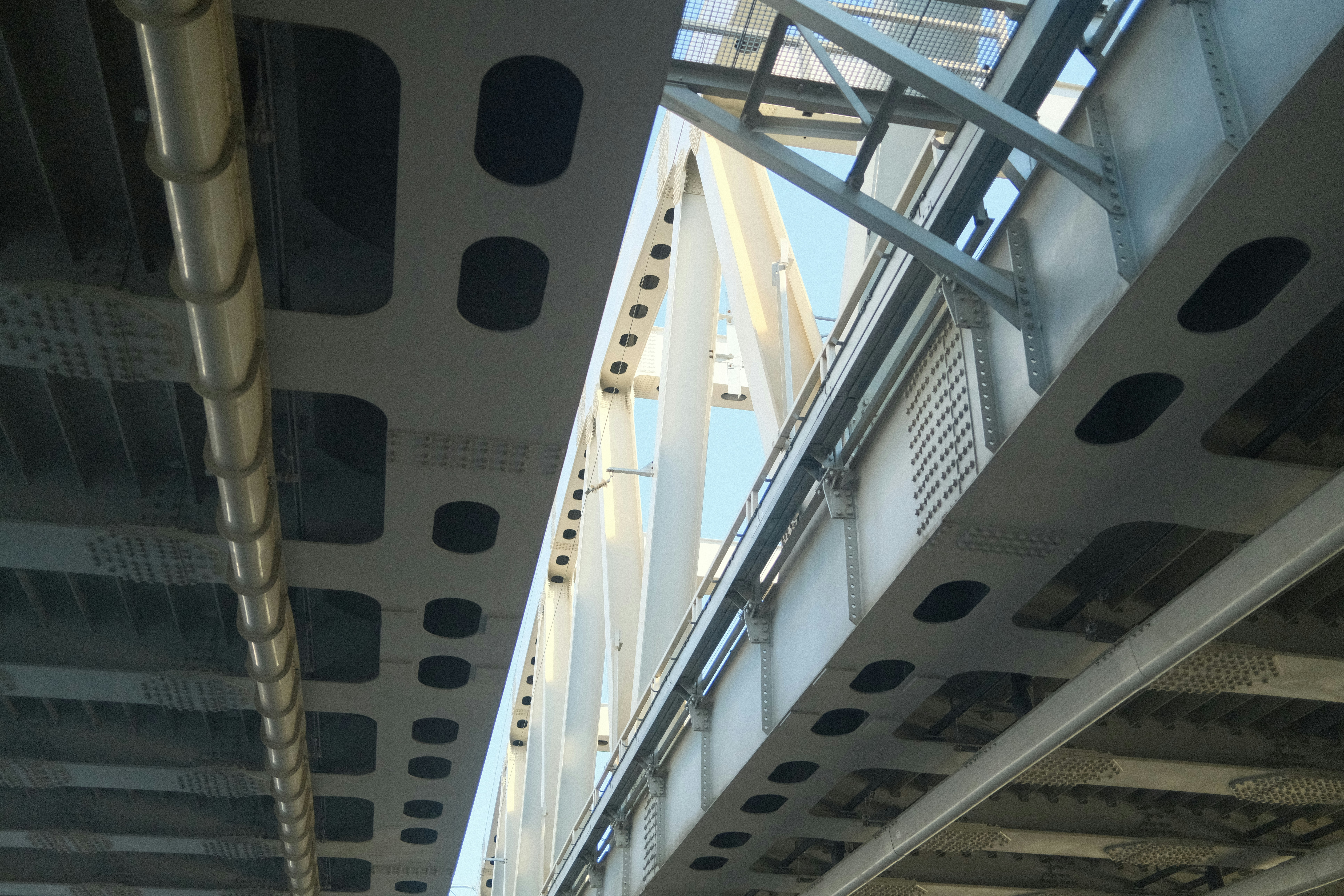 Looking up at the underneath of a bridge.
