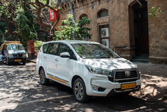 A white car parked on a city street.