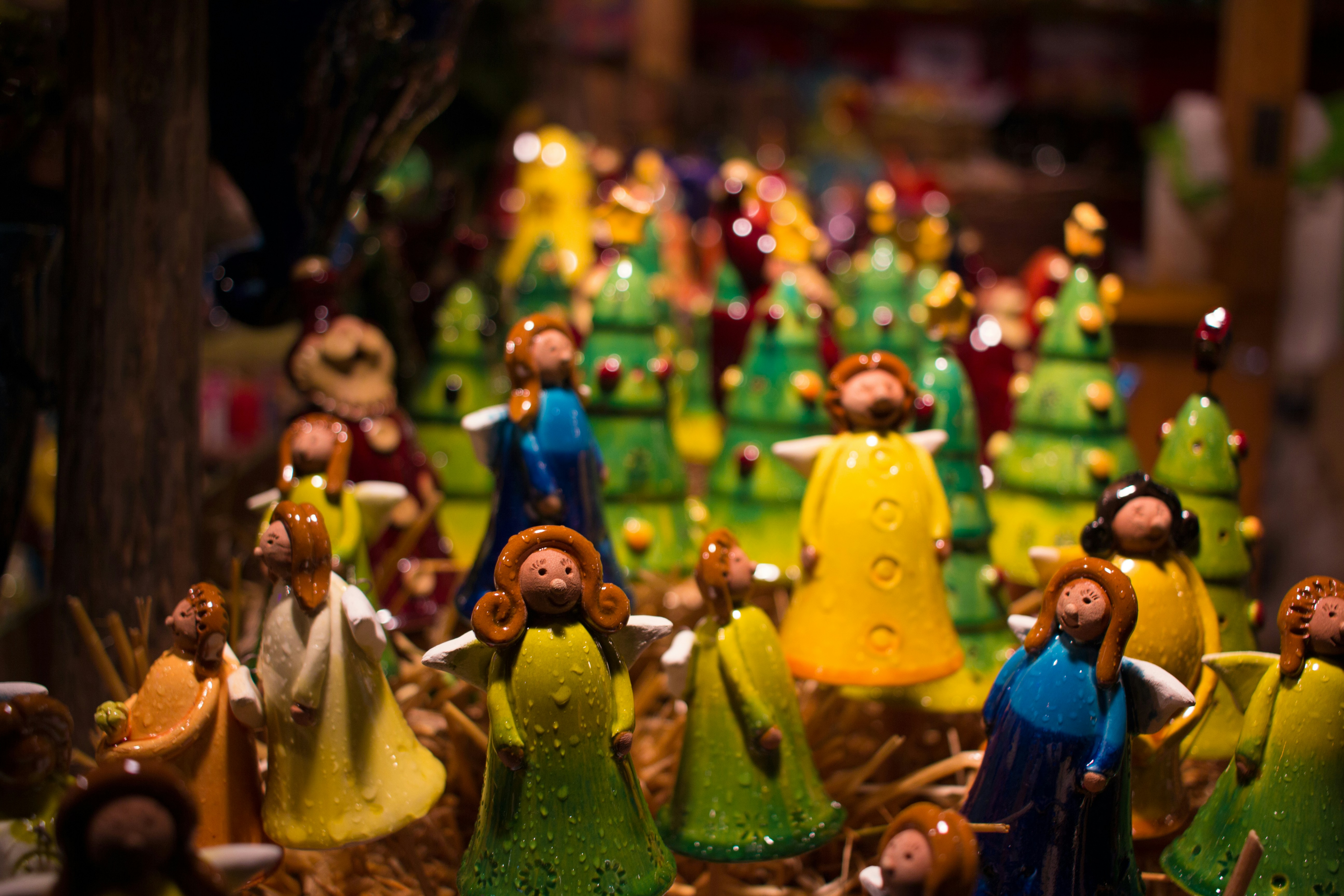 Vintage hand-painted ceramic figurines in folk art style with warm colors