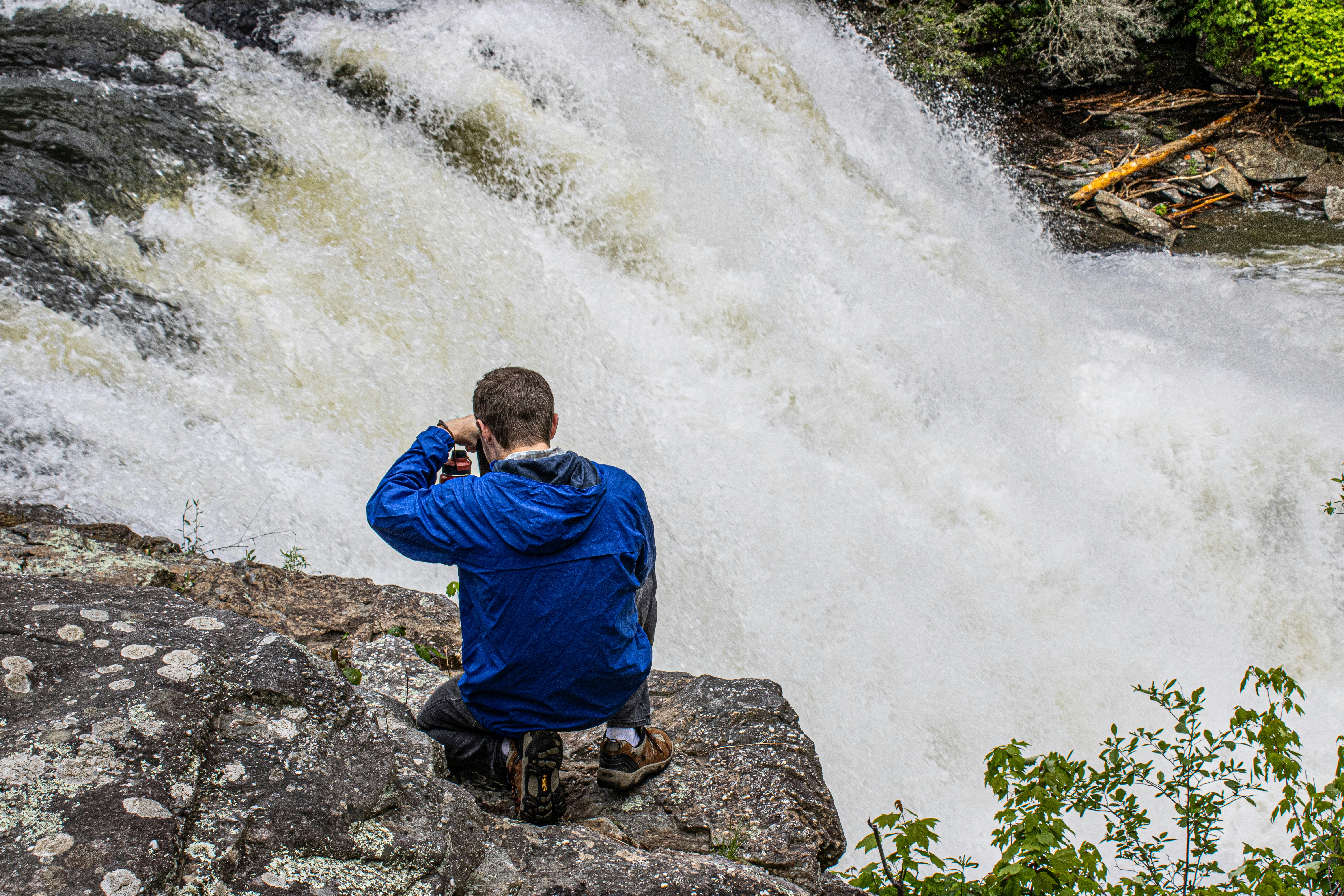 Man photographs a waterfall.