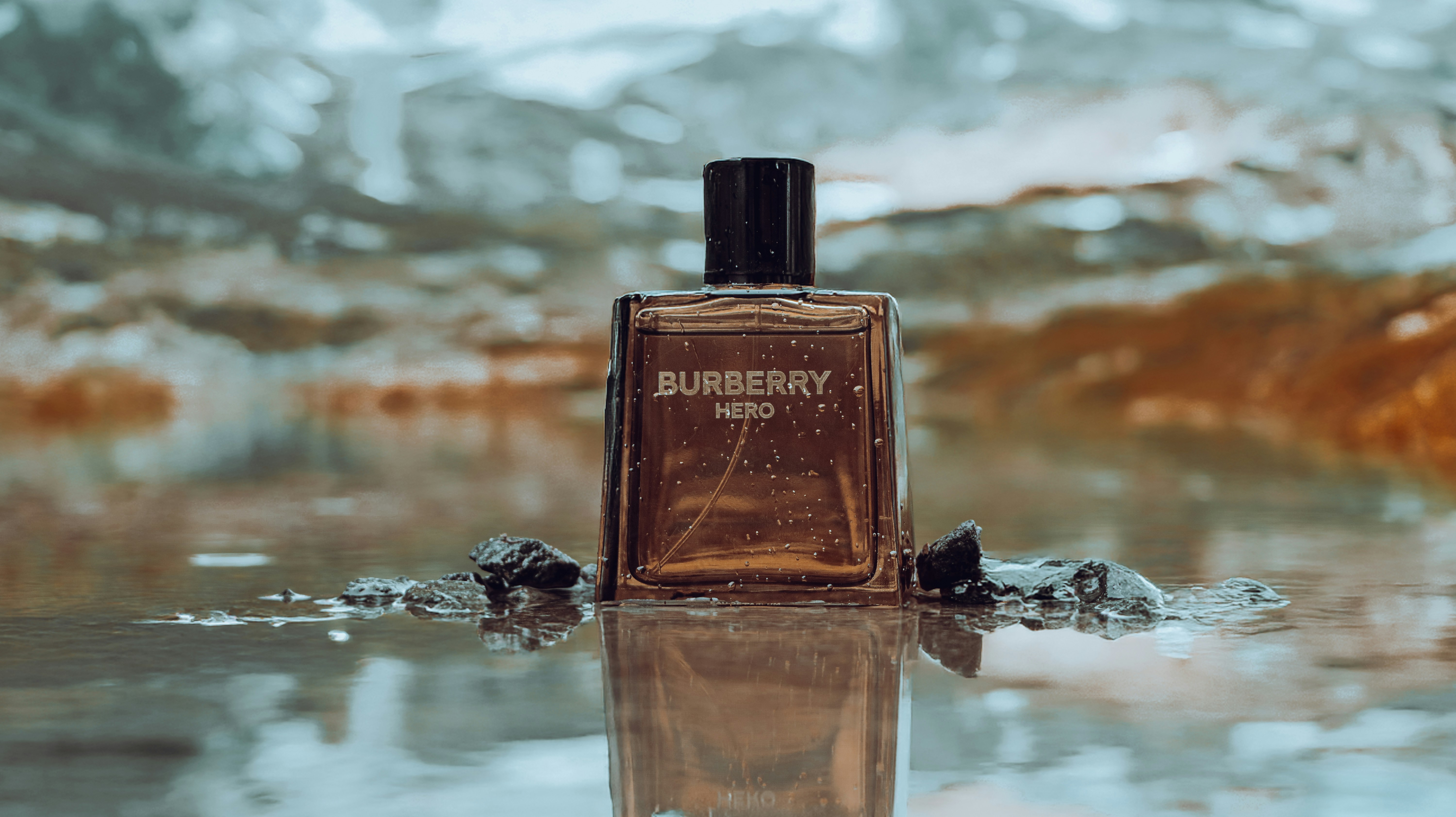 Burberry hero cologne sits in shallow water.