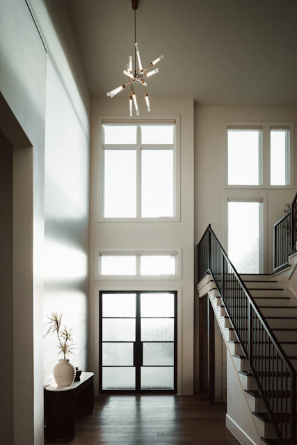 A bright, elegant entryway with a modern chandelier.