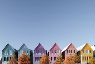 Colorful houses line a bright blue sky.
