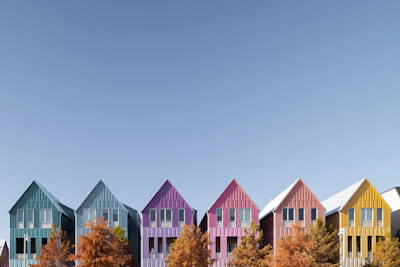 Colorful houses line a bright blue sky.