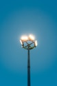 Bright lights shine against a blue sky.