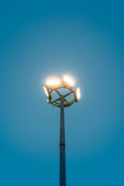 Bright lights shine against a blue sky.