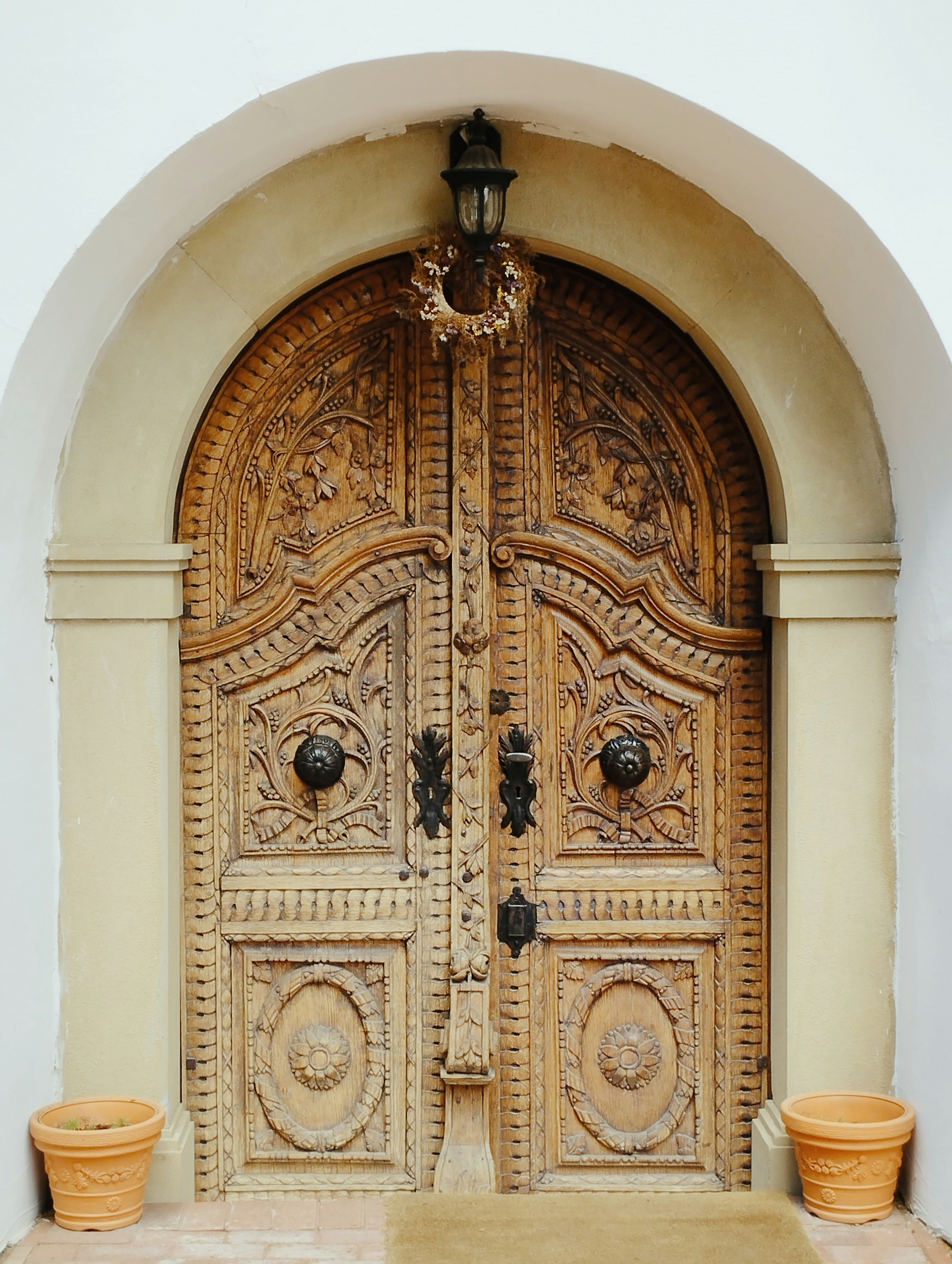 Here is a short caption for the image: an intricately carved wooden door is shown.