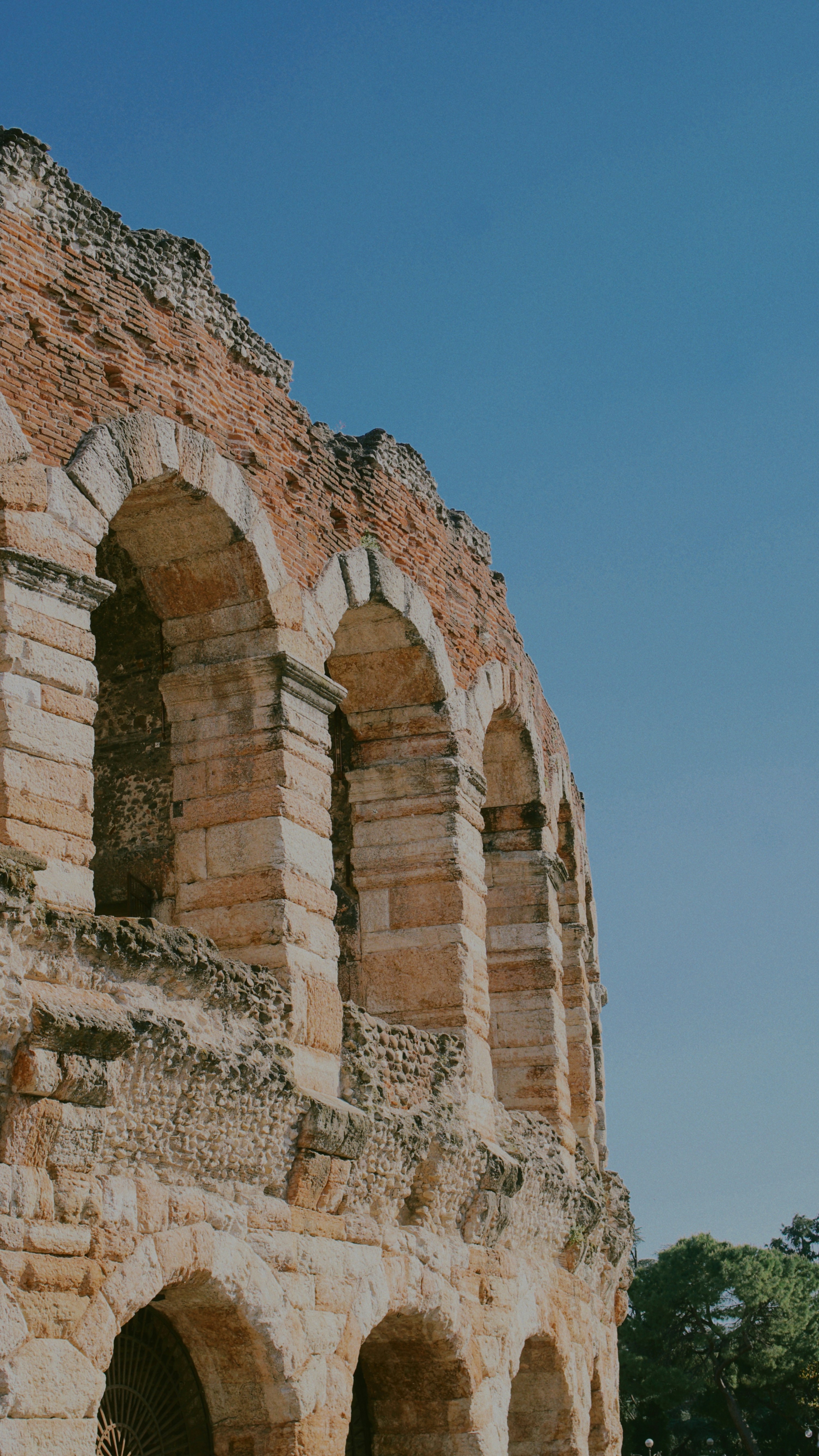 Ancient architecture with arches against a blue sky.