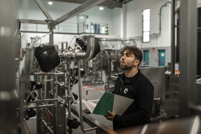 Factory workers carefully assembling products on a production line, representing quality and inspection