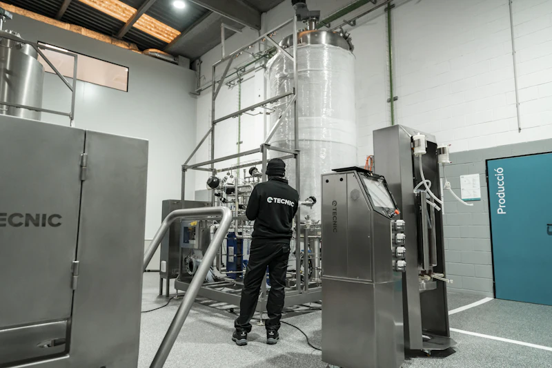 Technician supervising climate and production equipment in a controlled facility