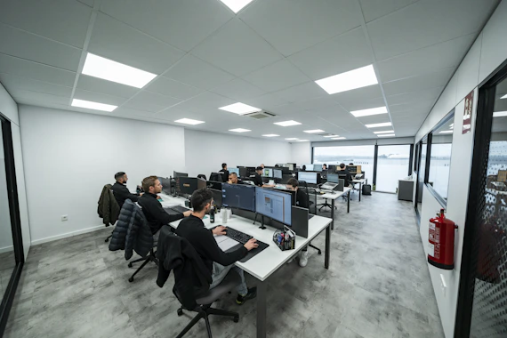 Office workers are busy working on computers.