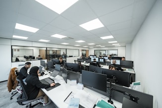 Office workers are busy working on computers.