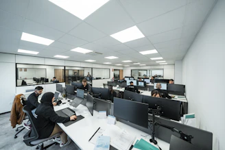 Office workers are busy working on computers.