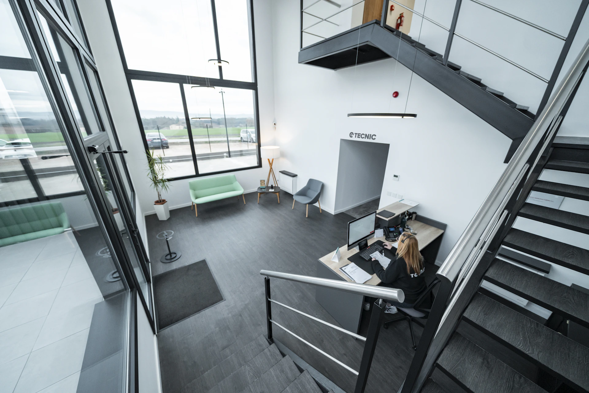 A modern office reception area with a staircase.