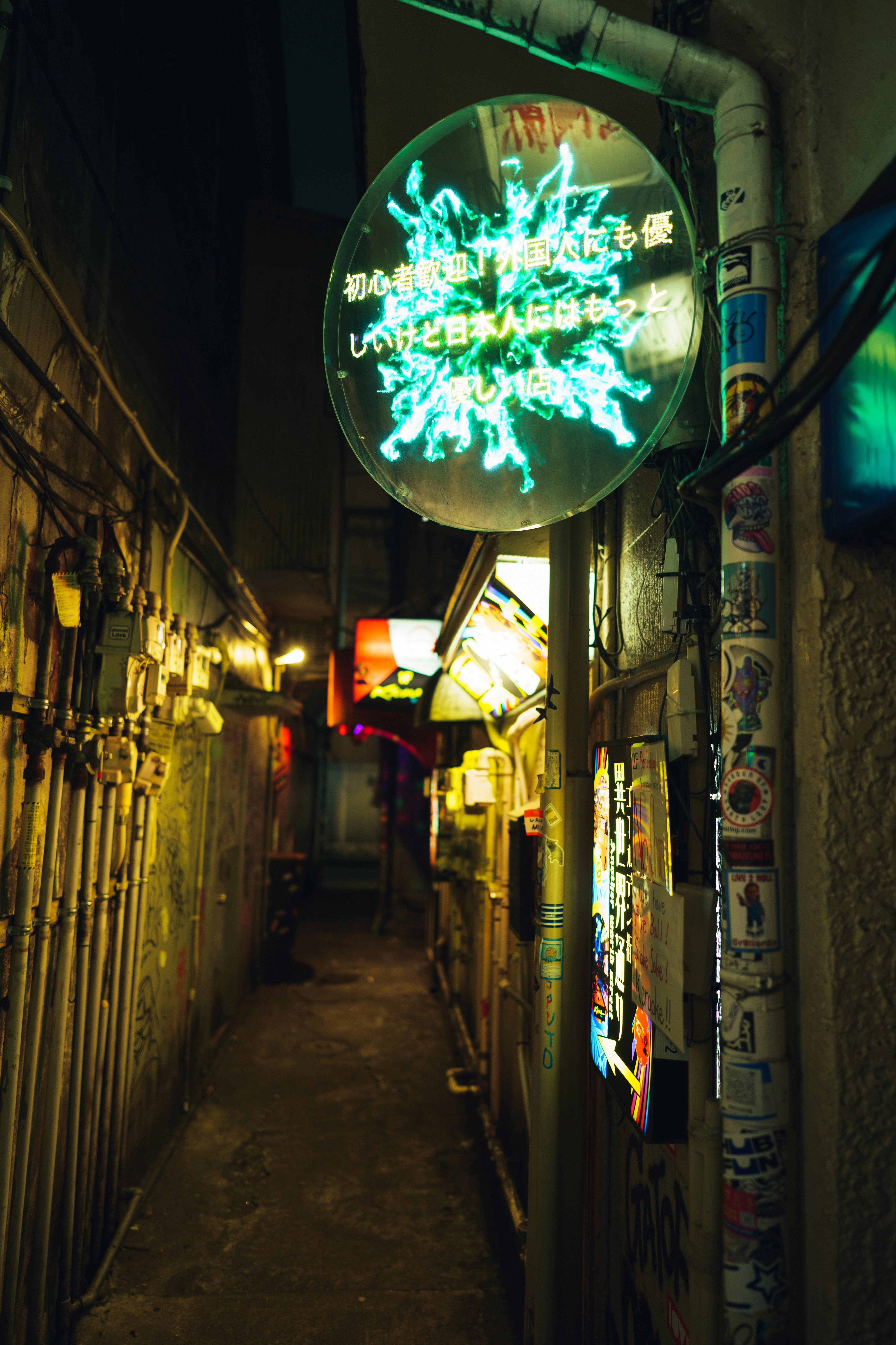 A narrow, illuminated alley at nighttime in japan.