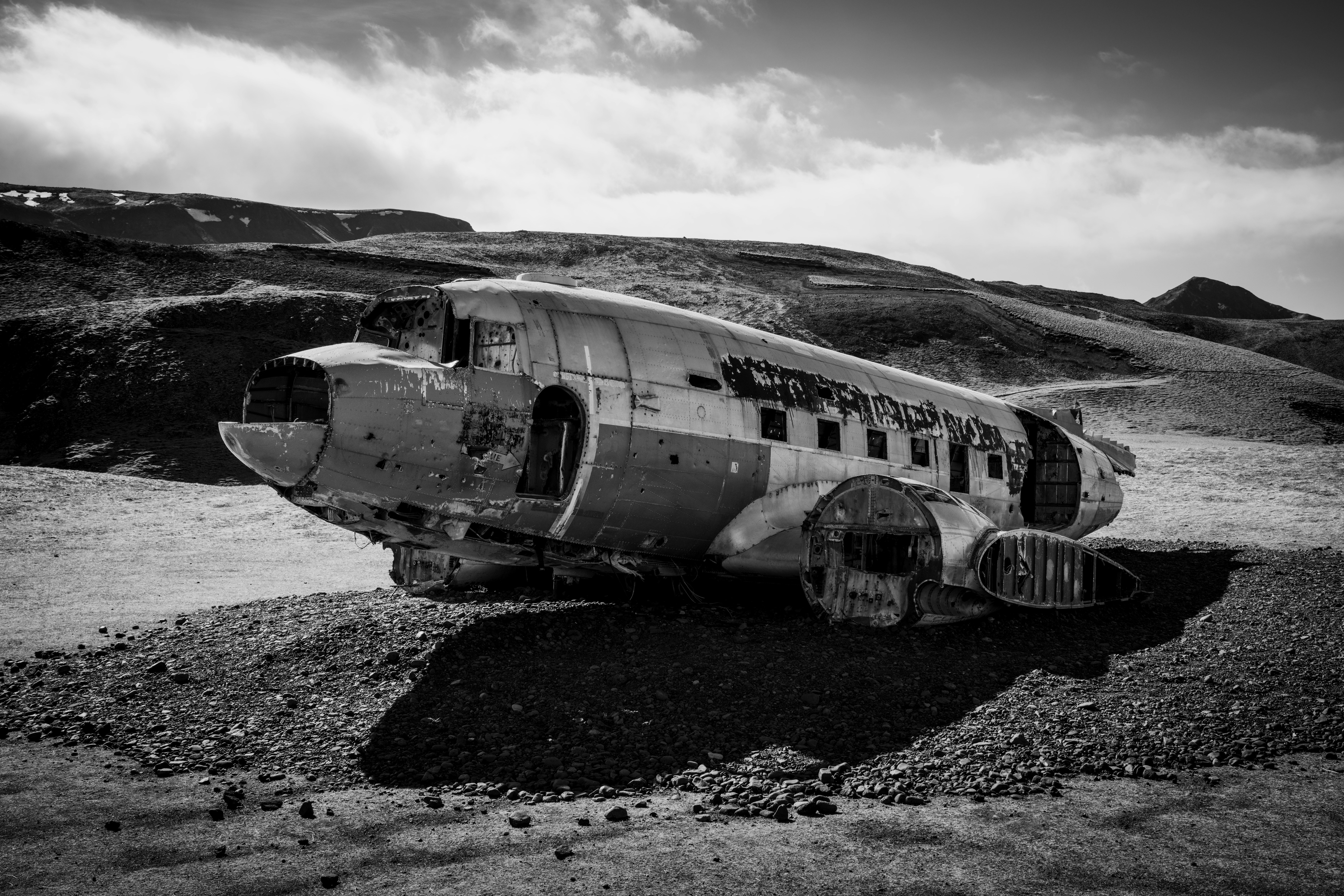 An abandoned plane wreck in a barren landscape.
