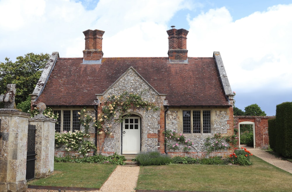 A small cottage with a terracotta tile roof among greenery