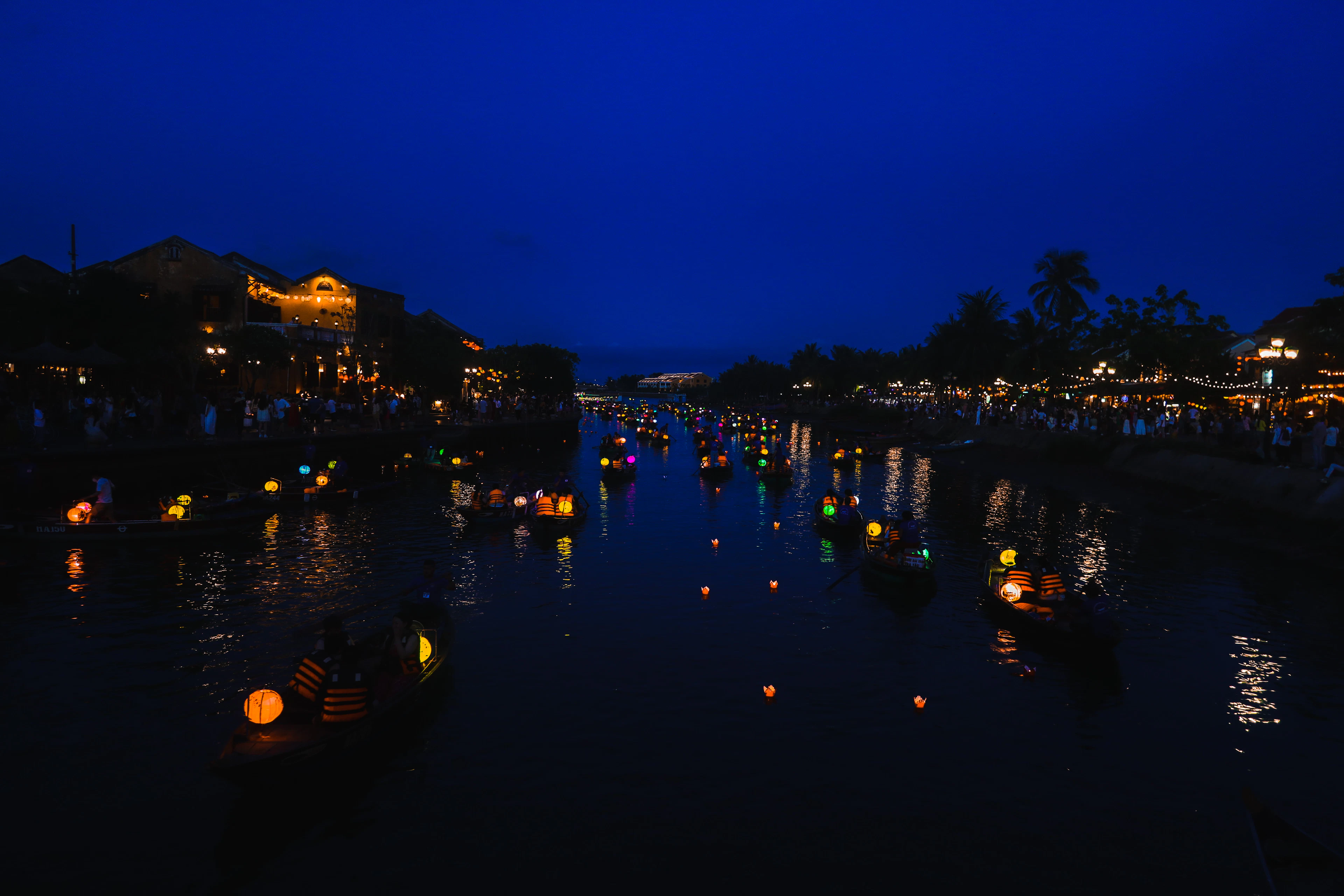 The Thu Bon river at Hoi An after dark, lanterns burning along both banks