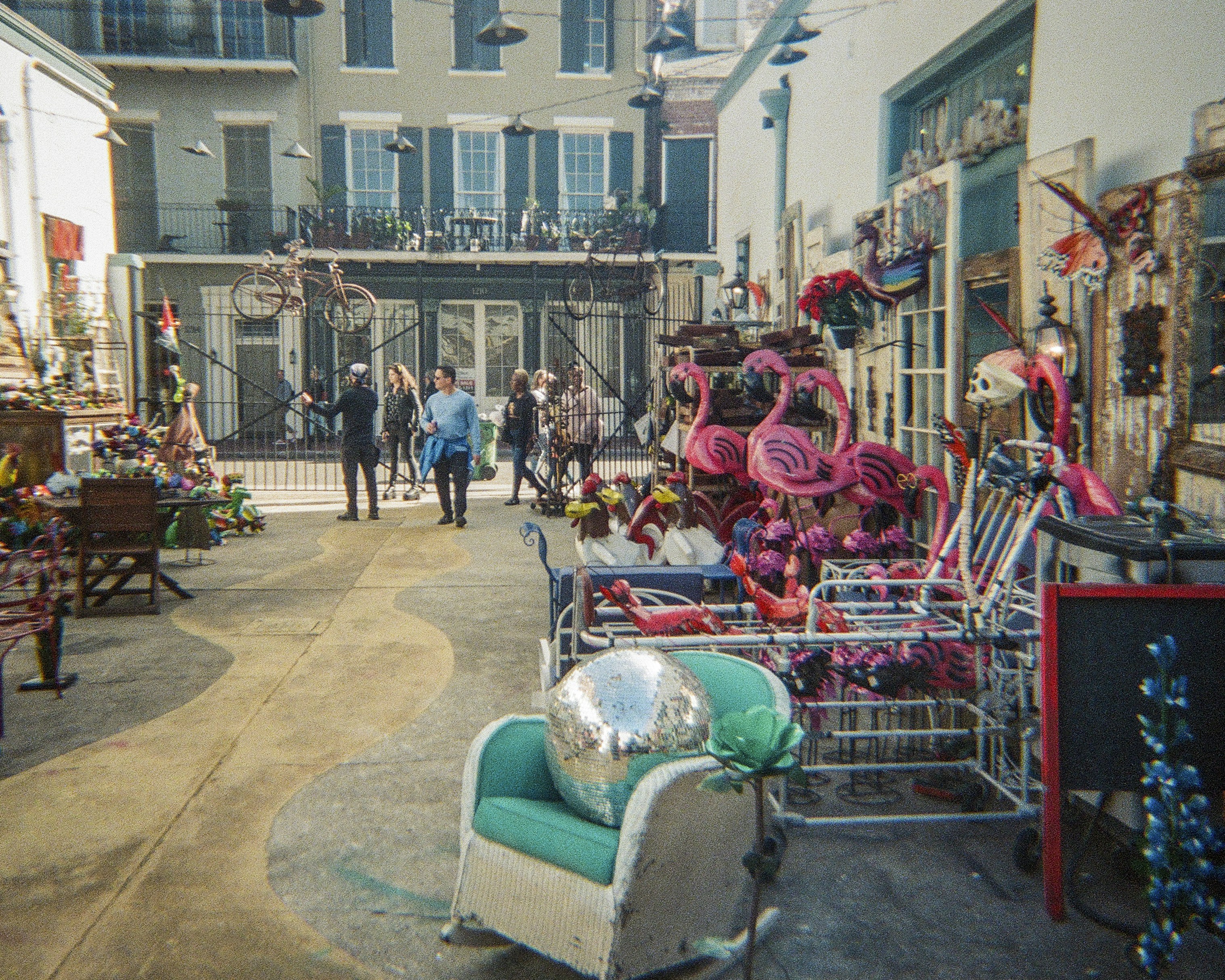 People stroll through a colorful outdoor market.