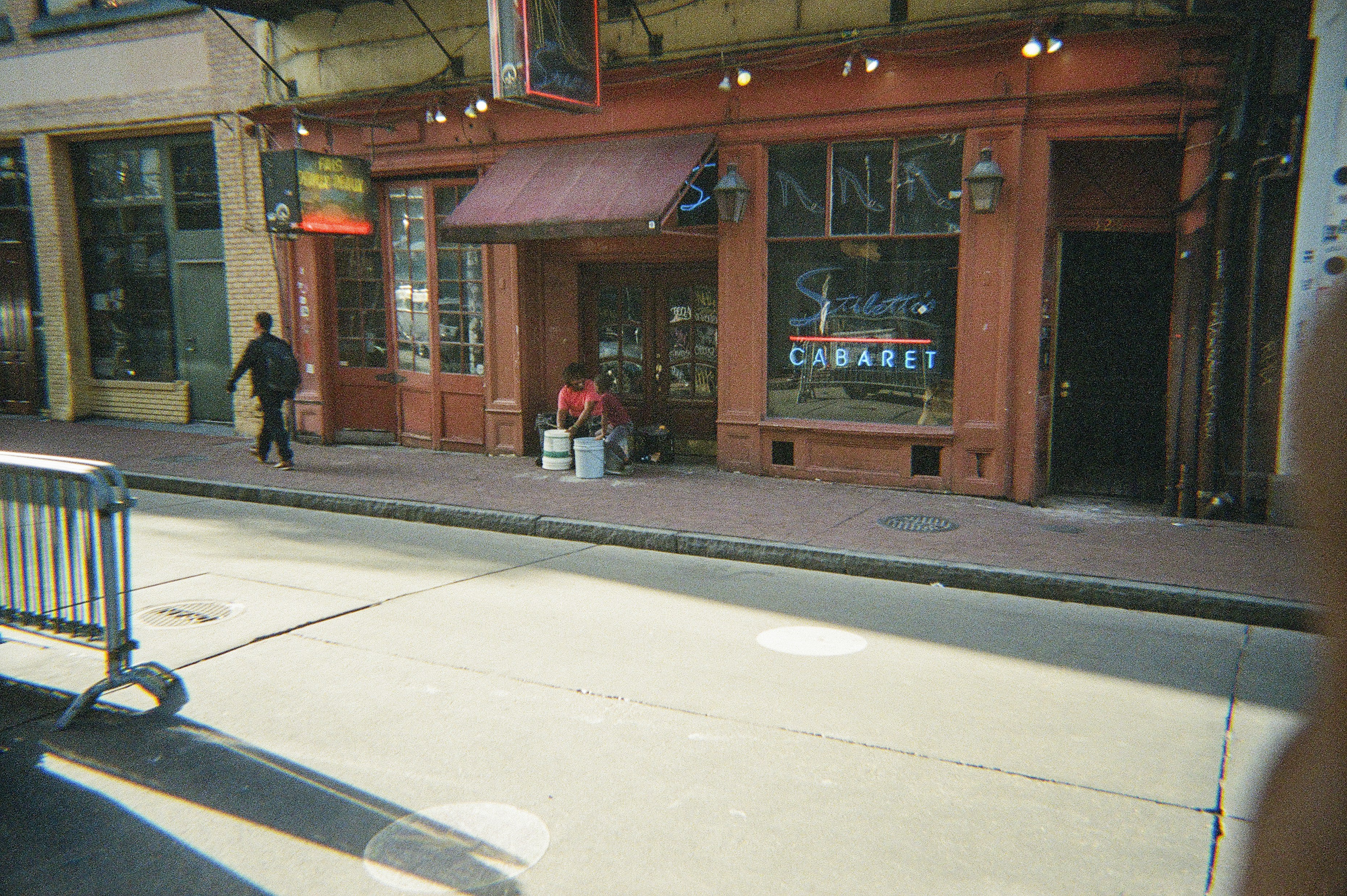 A red-fronted cabaret in a city street.