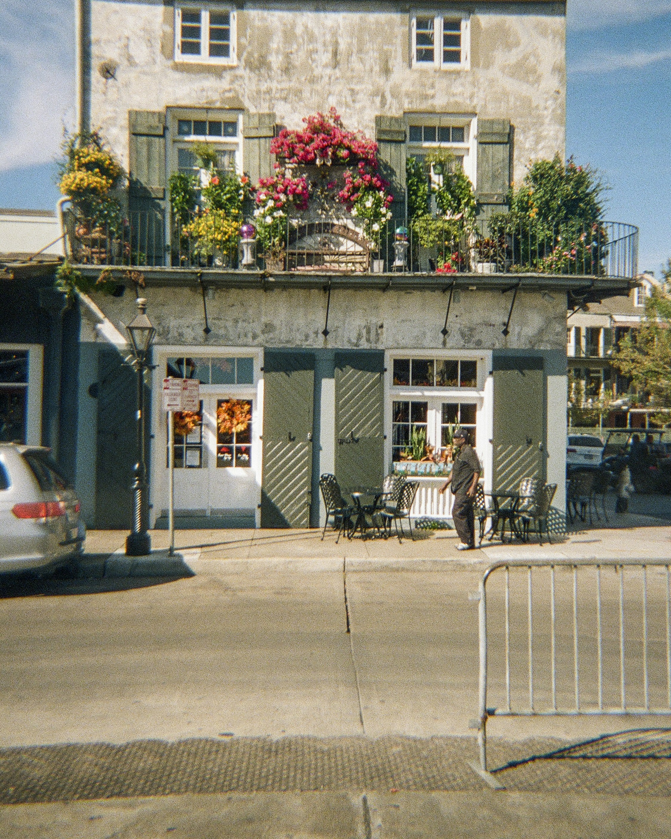 Beautiful balcony and storefront in a sunny cityscape.