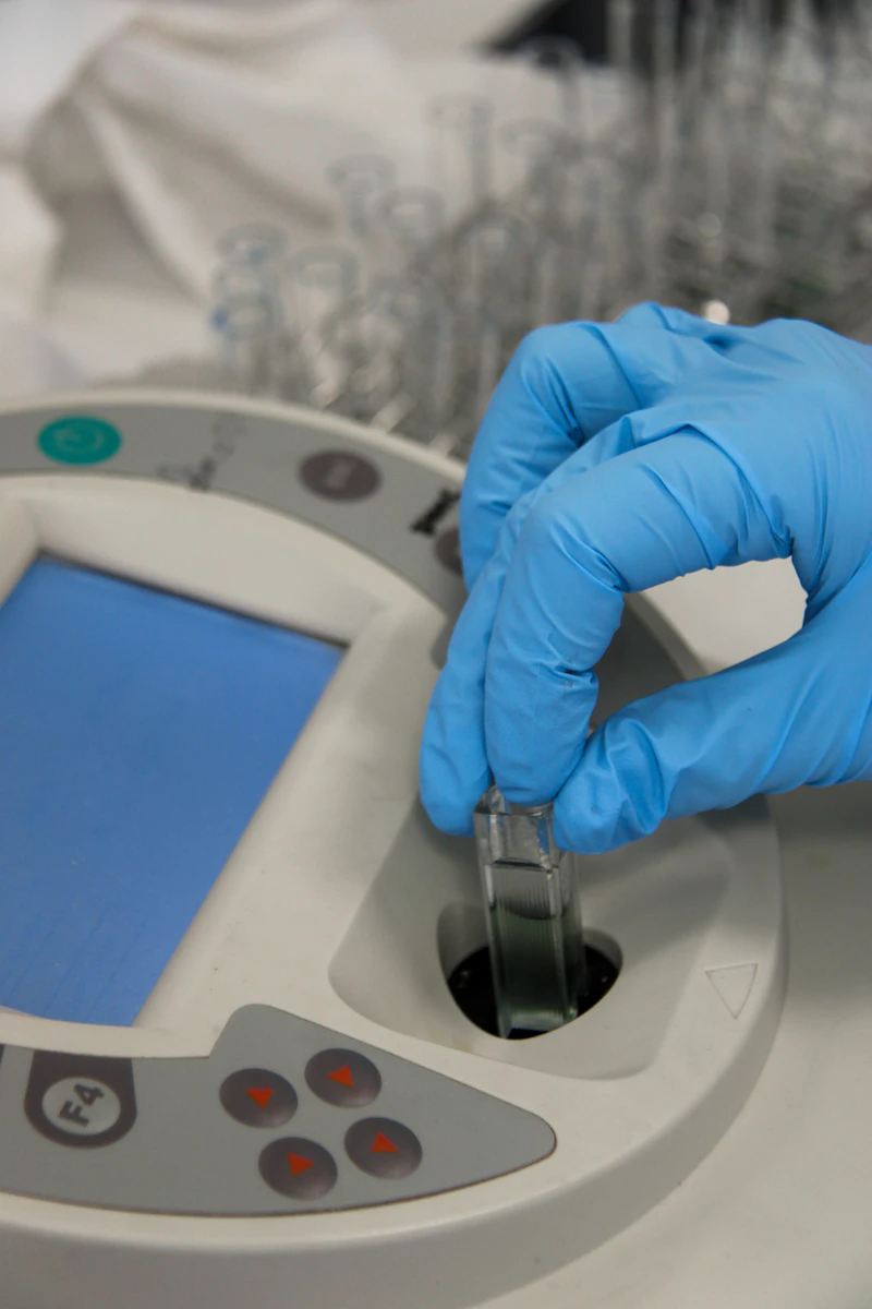 Laboratory technician testing a sample for chemical compliance