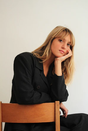 Woman in suit poses for a portrait