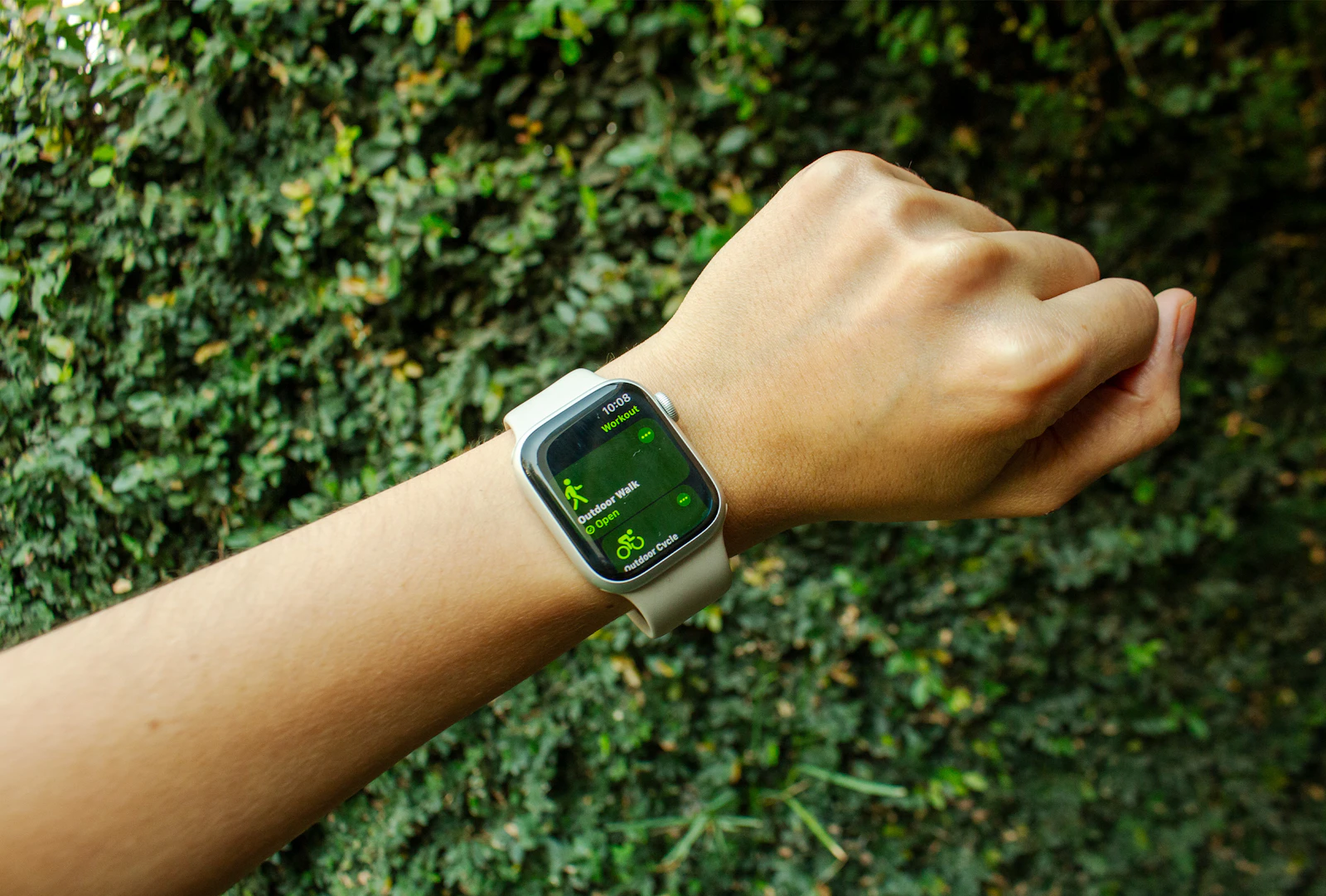 A person's wrist wearing an Apple Watch outdoors in natural light, the kind of everyday moment when Apple Watch heart rate alerts most often fire