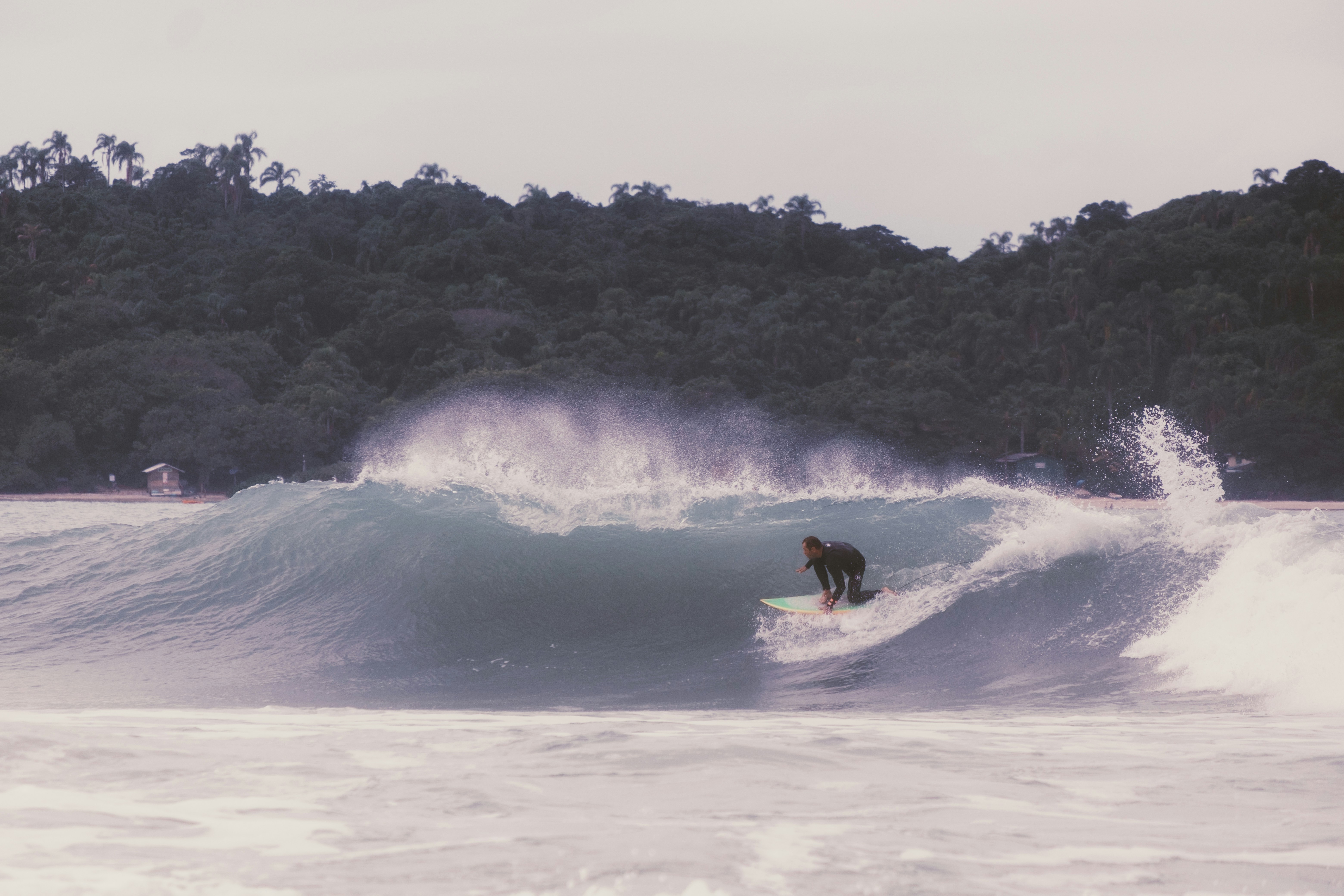 Surfer rides a big wave.
