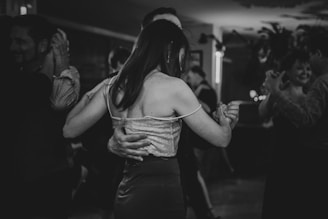 A couple dances together in black and white.