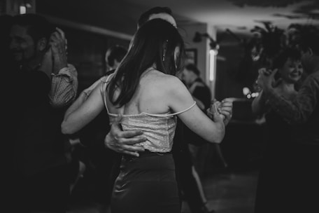 A couple dances together in black and white.