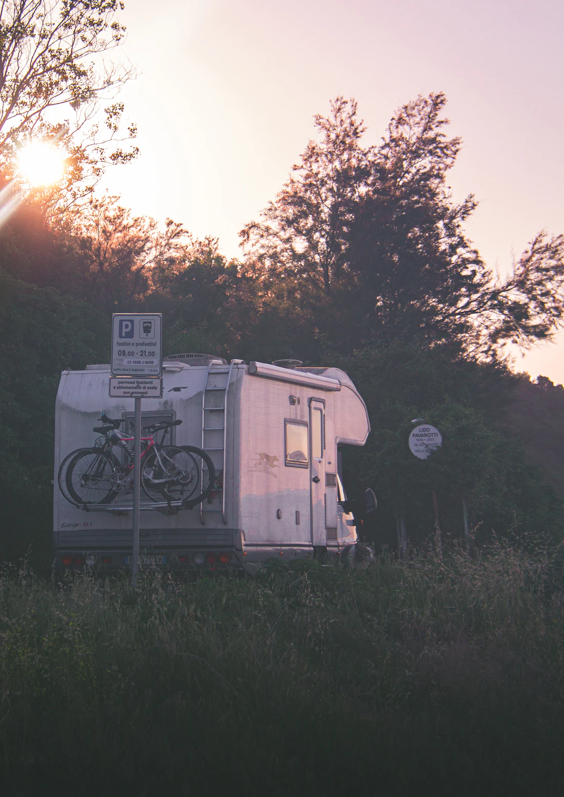 RV parked in nature at sunset, ready for summer