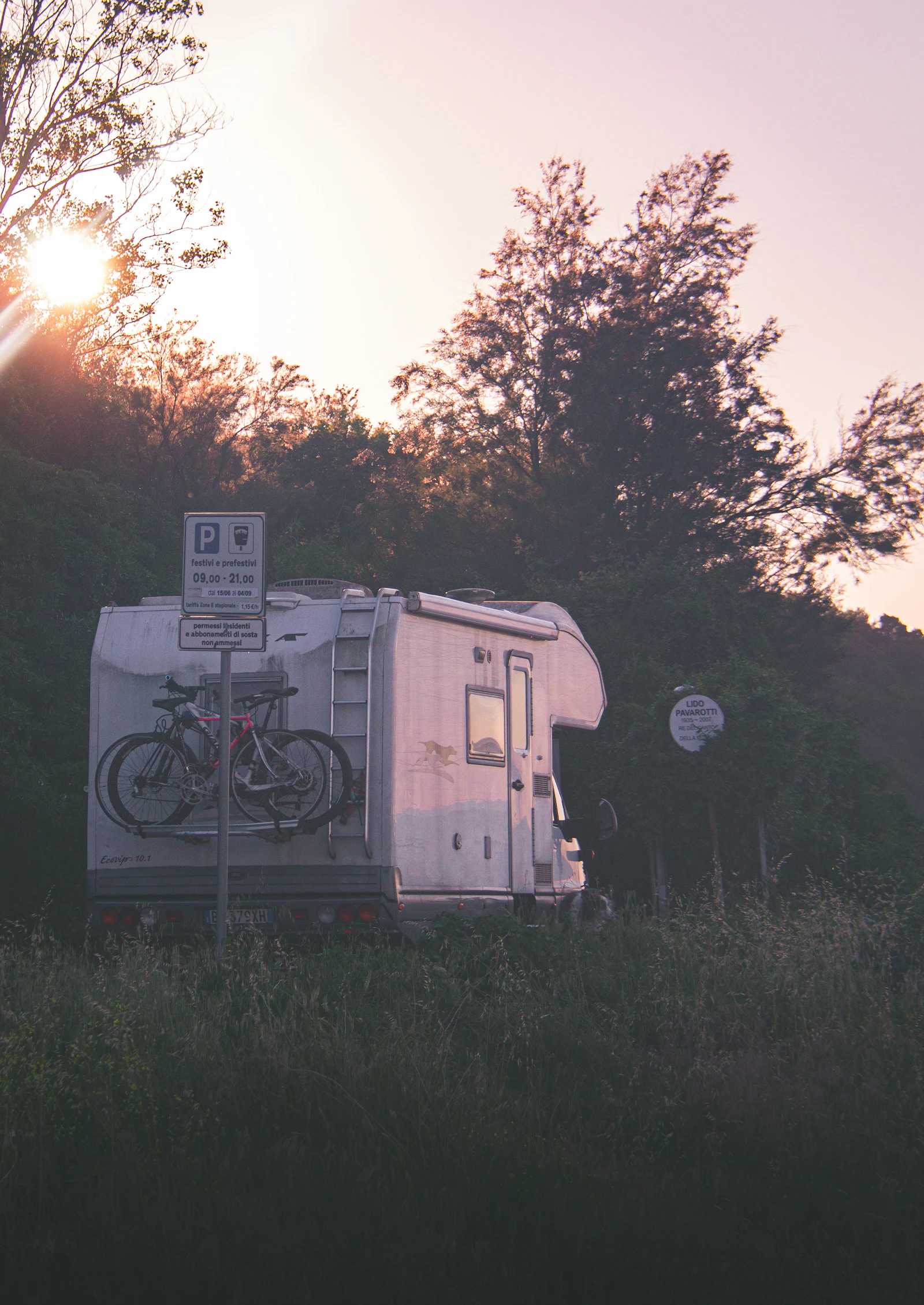 RV parked in nature at sunset, ready for summer