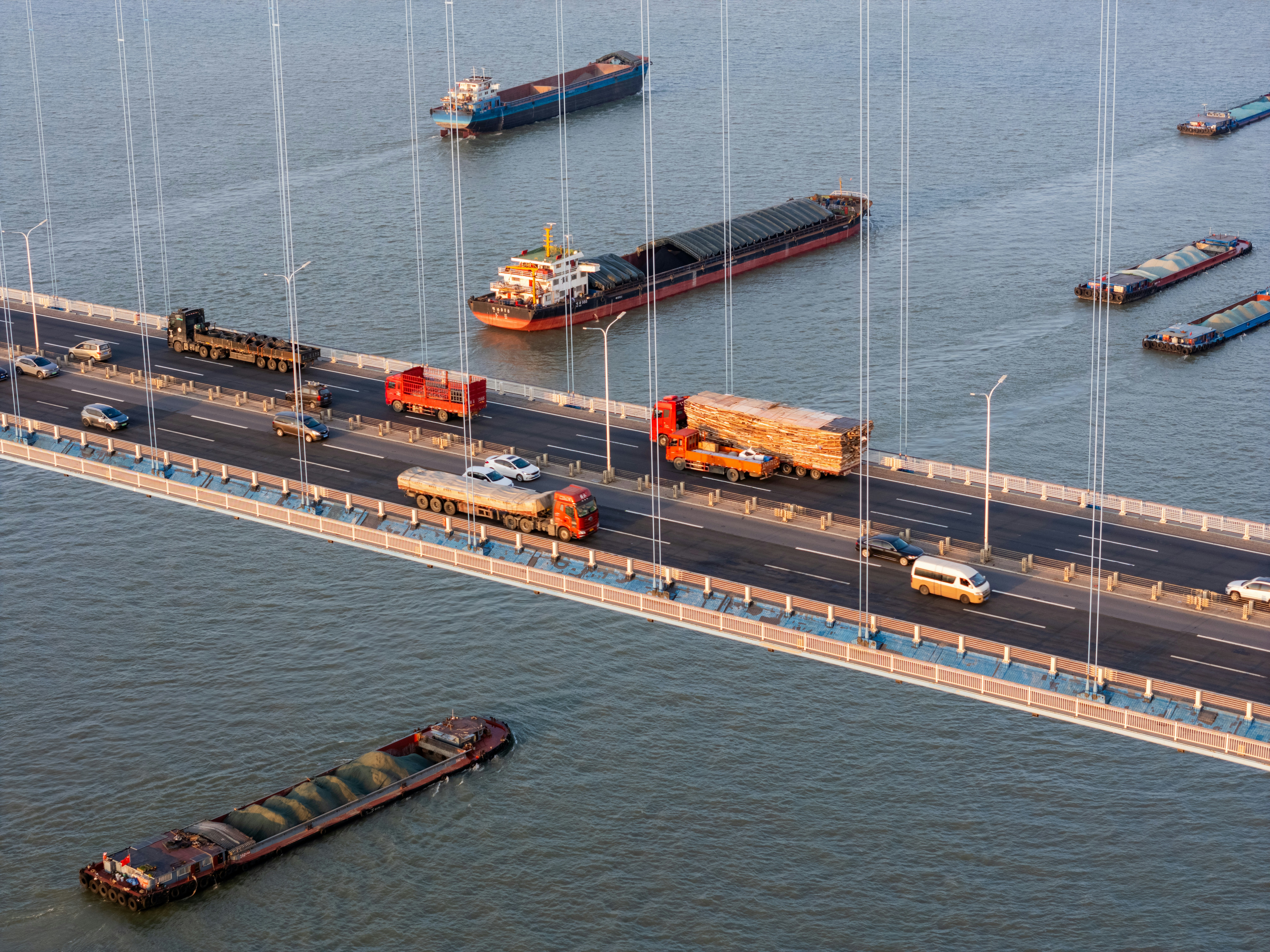 Bridges with trucks and cargo ships.