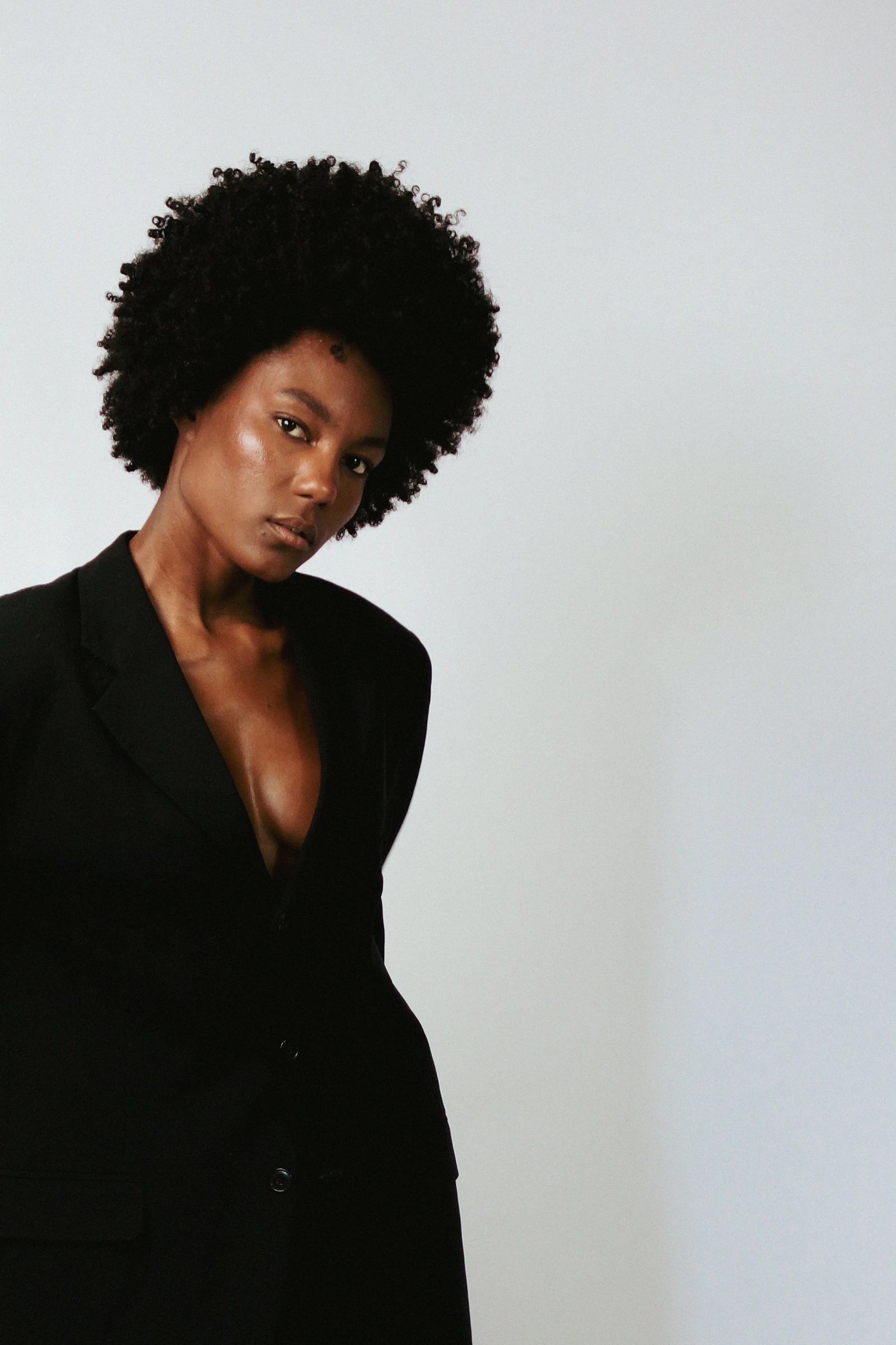 A confident businesswoman in a black blazer, composed and professional