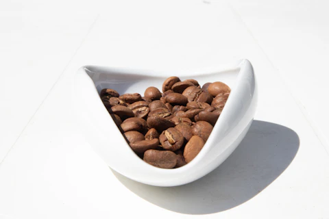 Coffee beans in a white ceramic bowl
