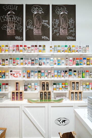 Spray paint cans are neatly organized on shelves.
